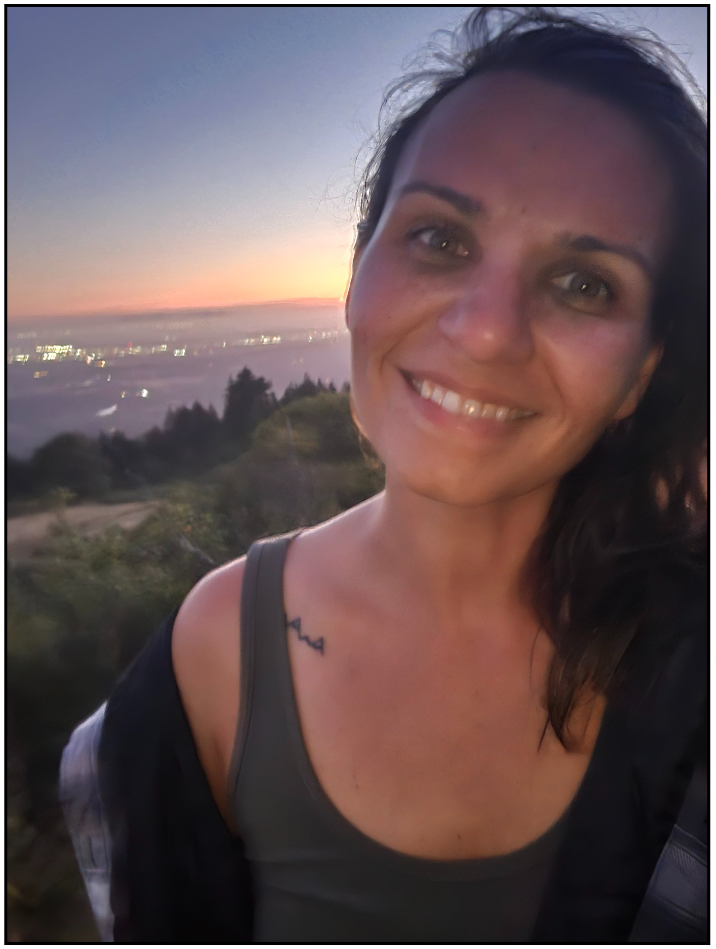 Coach Jenn at sunset mountain top