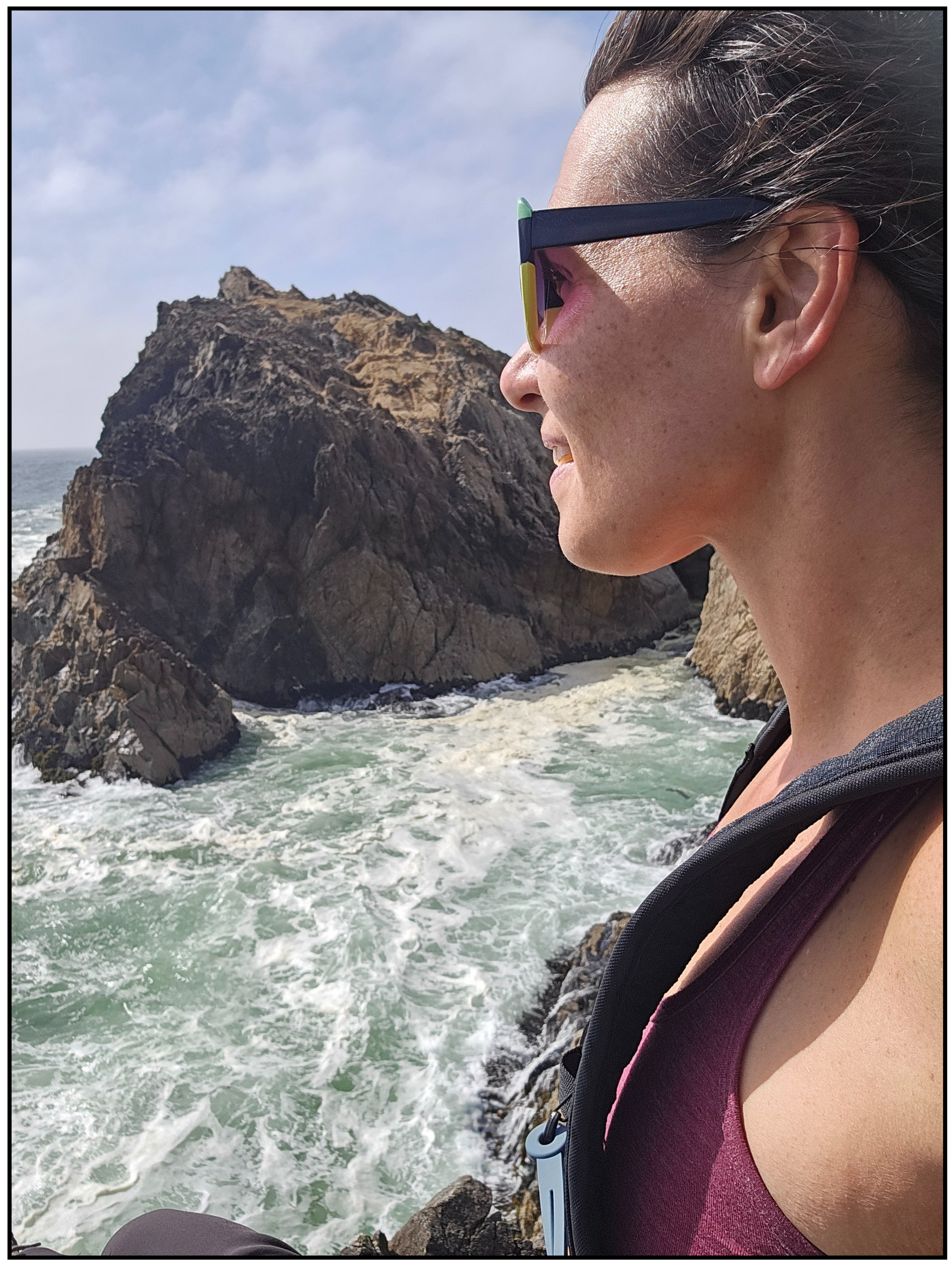 Coach Jenn at the ocean, with focus and balance