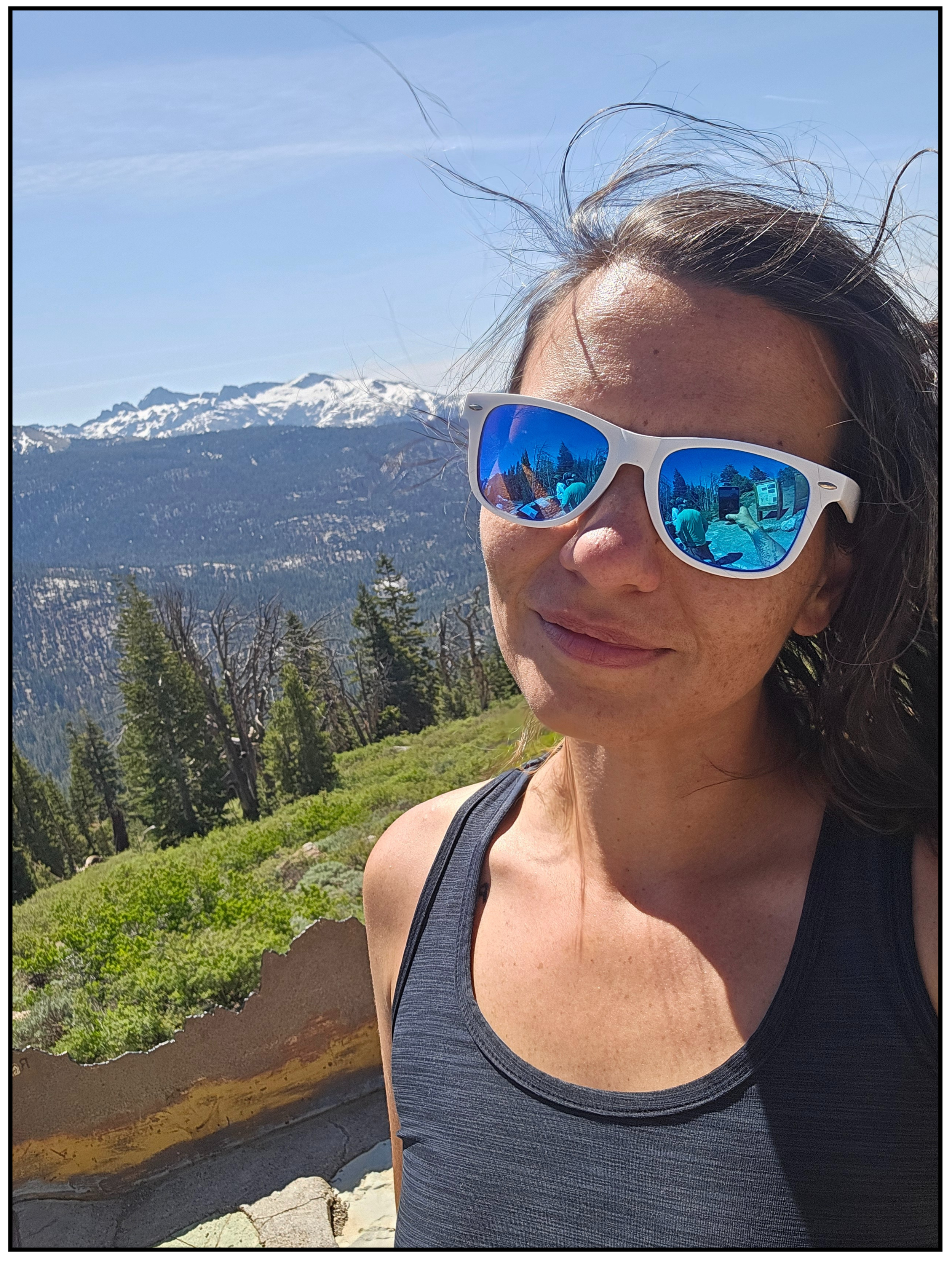 Coach Jenn hiking in the mountains promoting clarity and focus