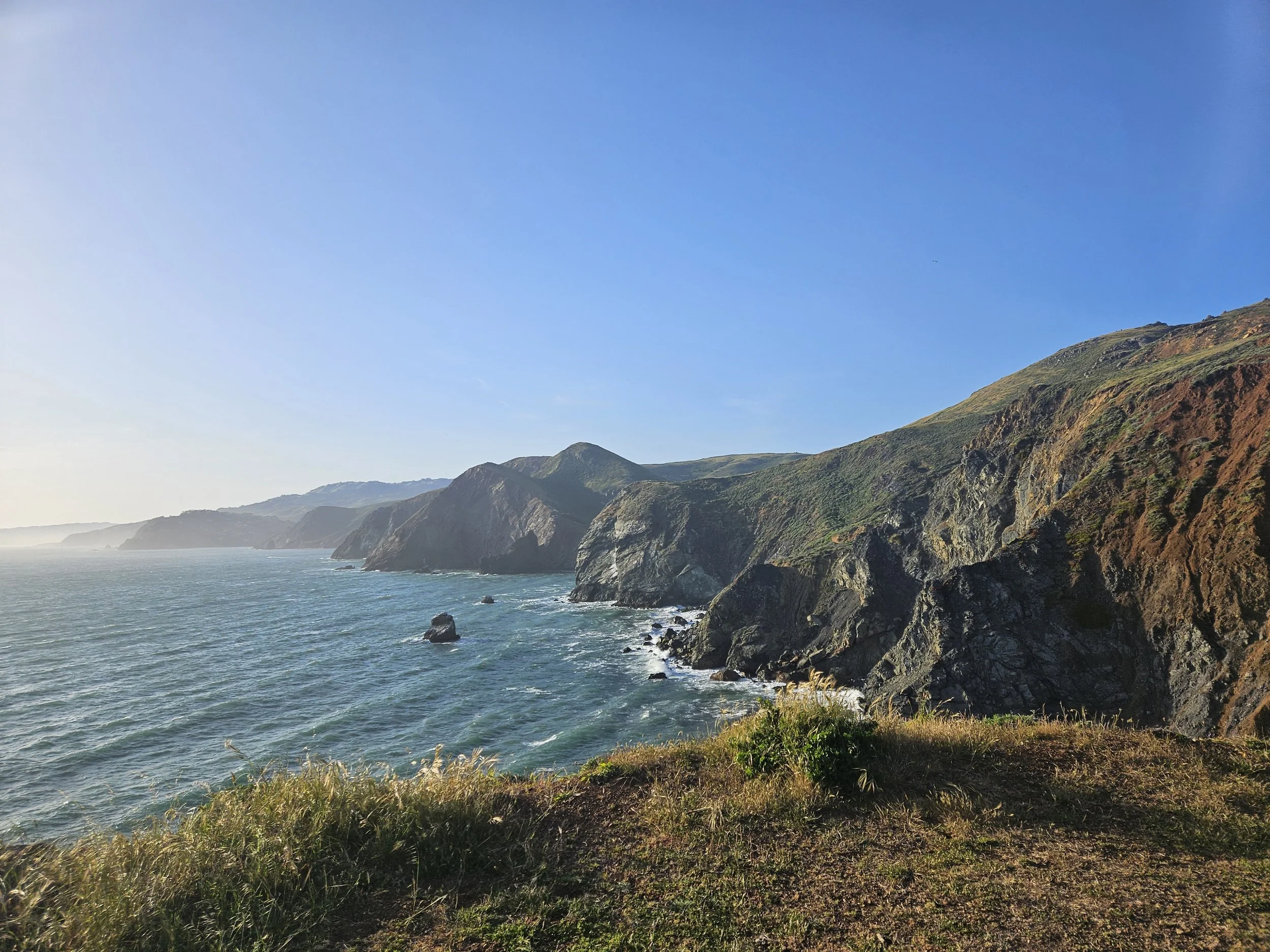 mountains in the bay with rocky shore and ocean waves