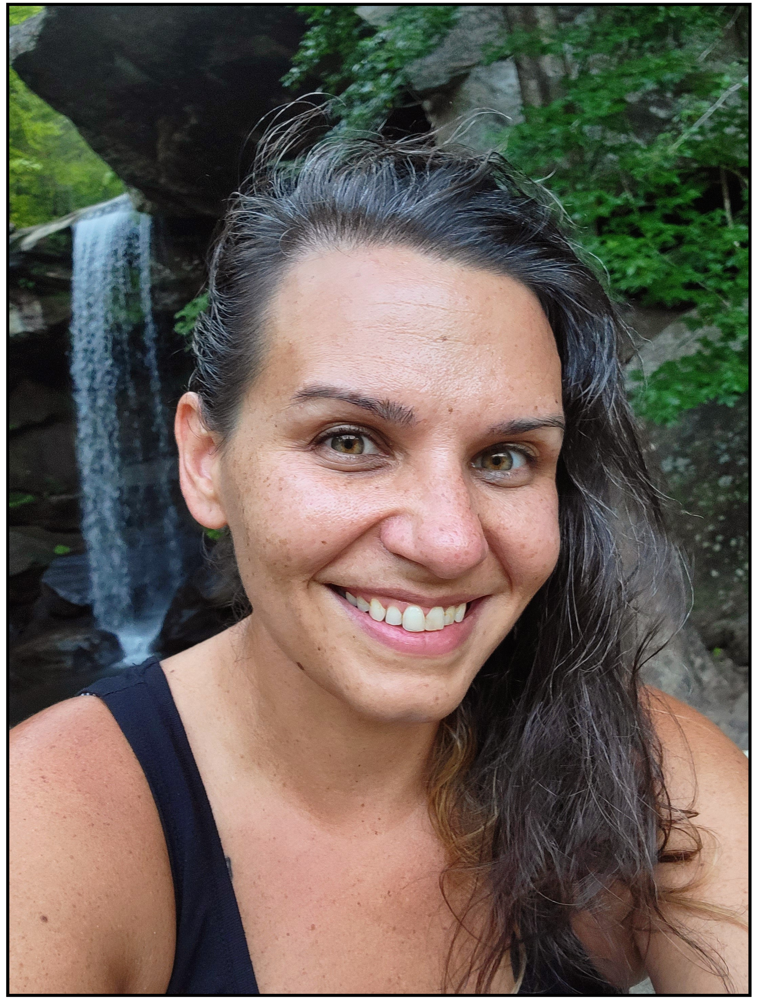 Coach Jenn under a summer waterfall, embracing growth and renewal