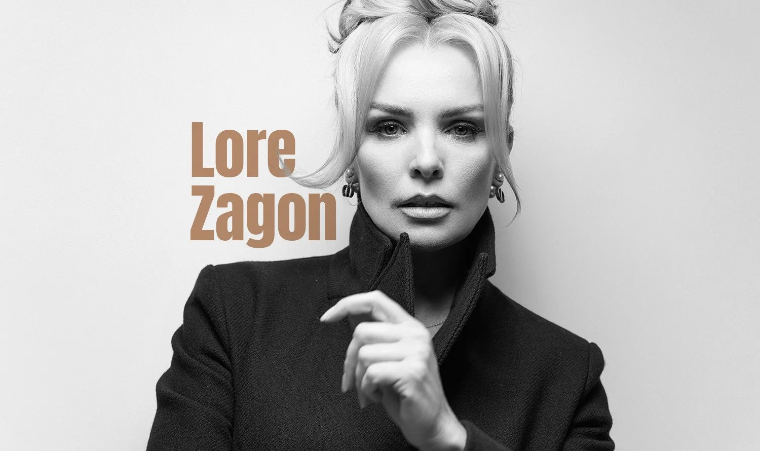 Black and white portrait of a woman with short, blonde hair, wearing a black turtleneck and earrings, looking directly at the camera with a serious expression; text overlay reads "Lore Zagon" in large brown letters.