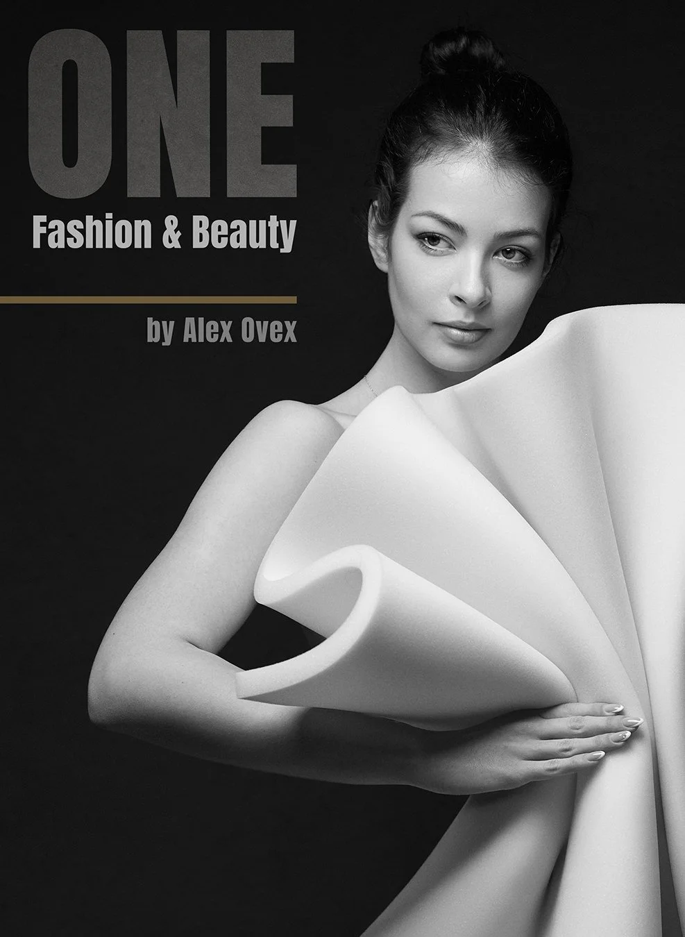 Black and white photo of a woman holding a large folded sheet of paper or fabric, with text indicating a fashion and beauty book titled "ONE" by Alex Ovex.