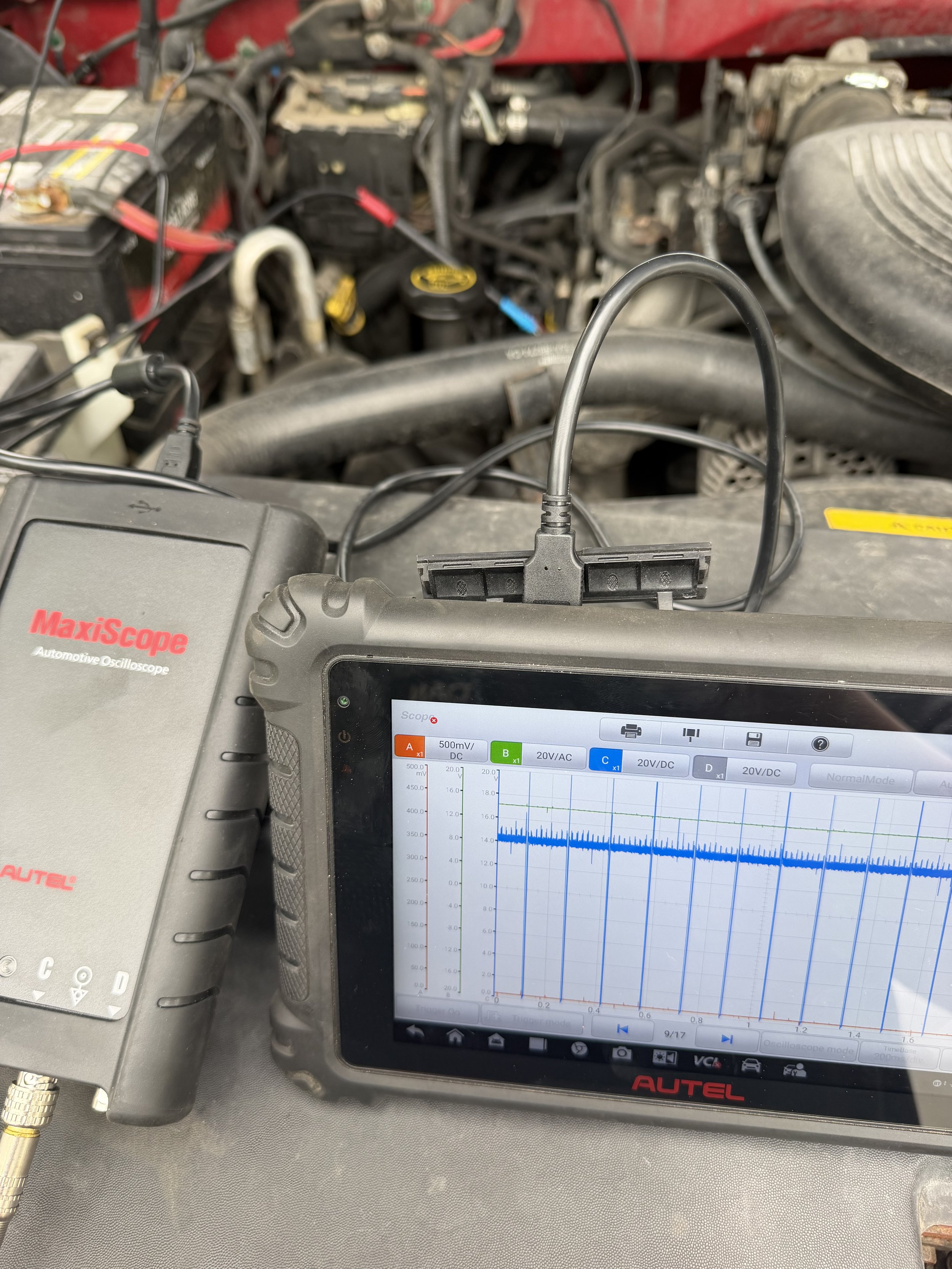 mechanic in fort wayne using an oscilloscope which is an advanced diagnostic tool. mobile mechanic performing car repair in Fort Wayne.