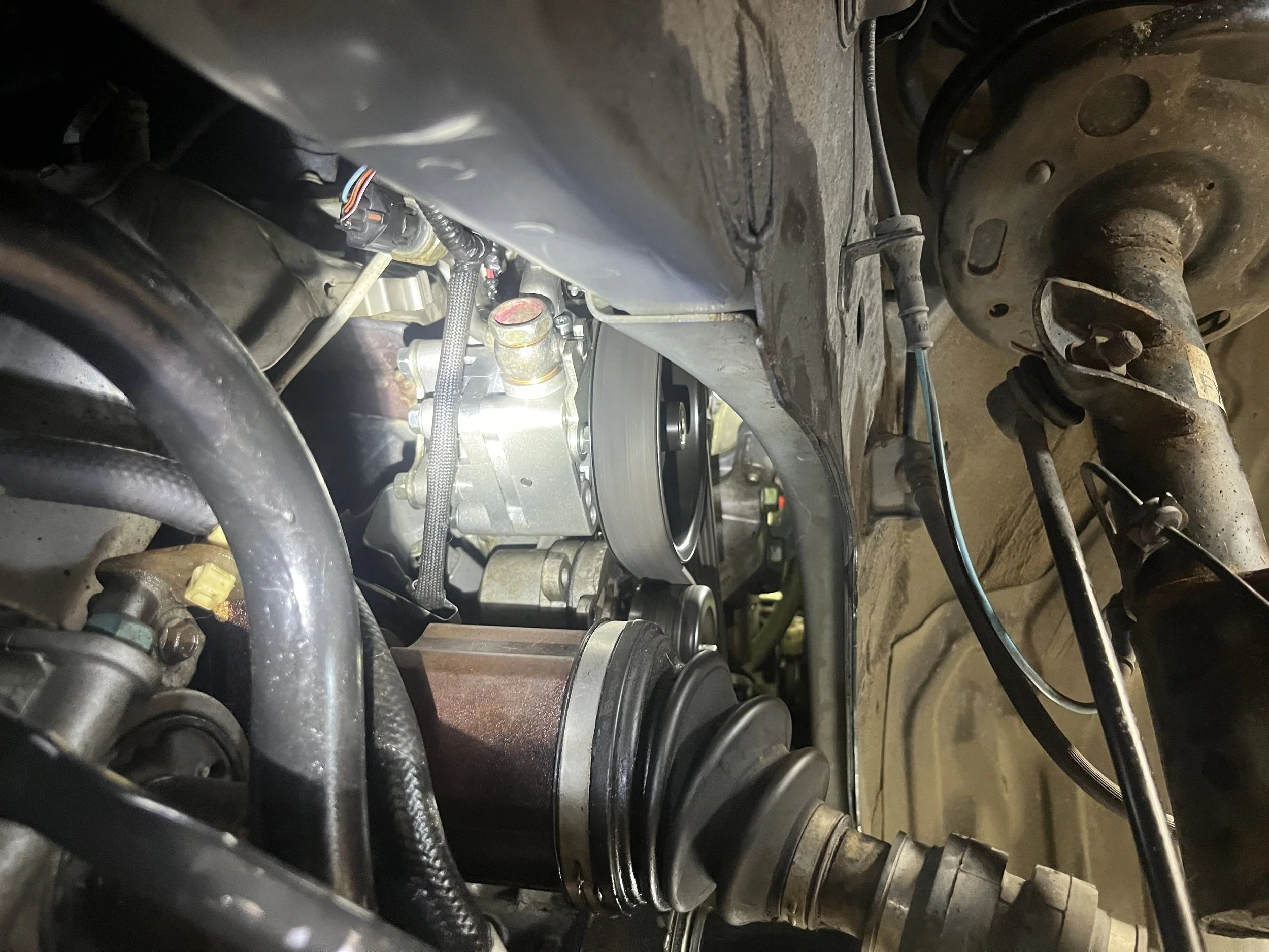 Mobile mechanic fort wayne installing a power steering pump. the photo was captured by a mobile mechanic as he installed a nissan pathfinder power steering pump. the photo was taken in a fort wayne garage being serviced by fort wayne mobile mechanics