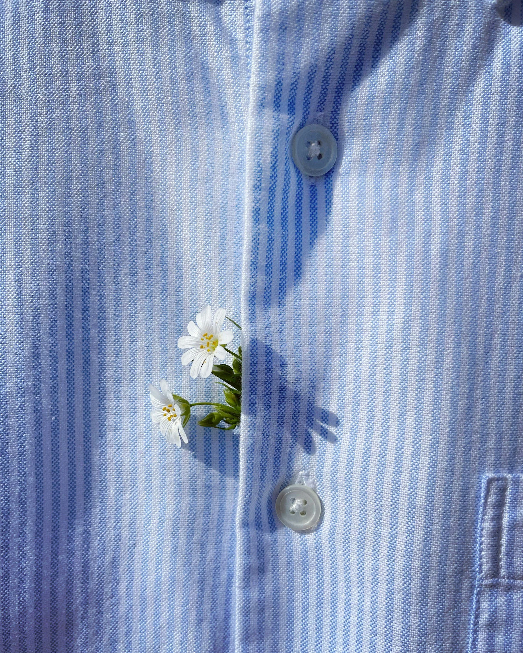 Button up shirt made of a natural fiber with a white flower poking out. Found at Share Club, a thrift store and community space in West Adams / Jefferson Park