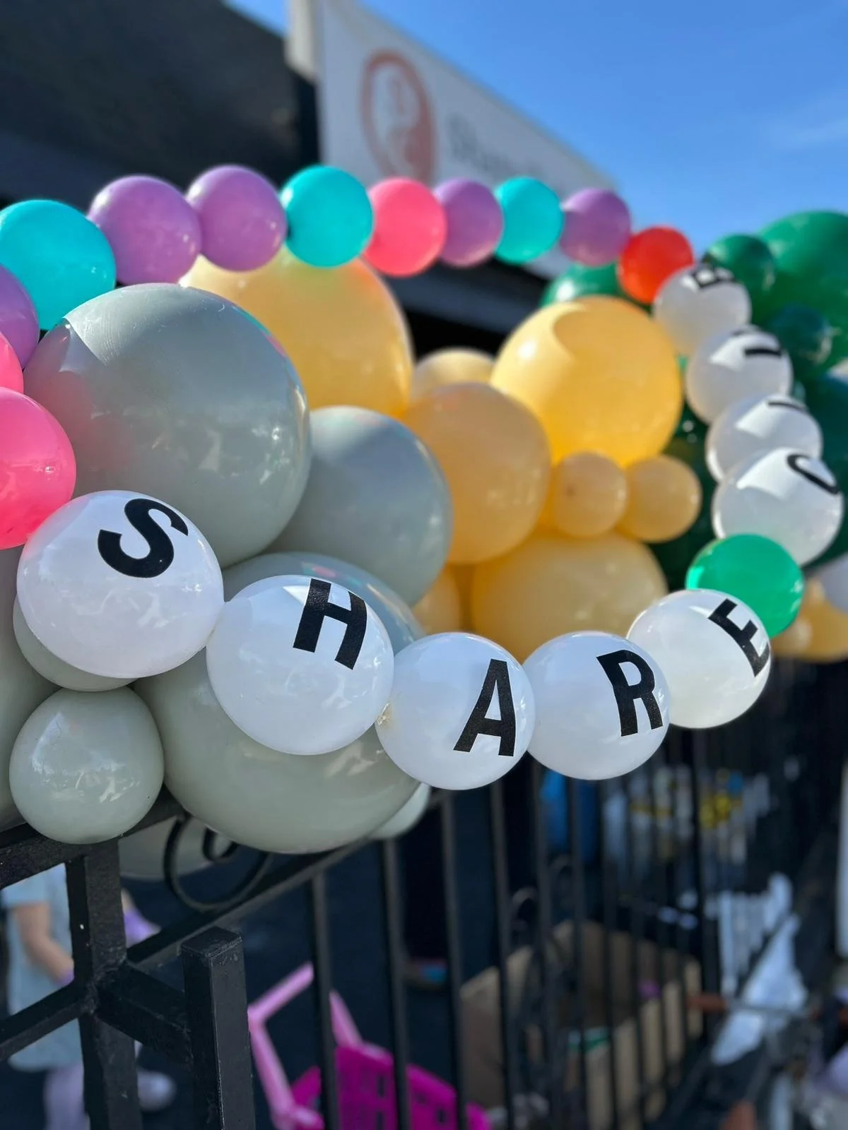 Multi-colored balloons that say Share Club, a thrift store and community space in West Adams/Jefferson Park