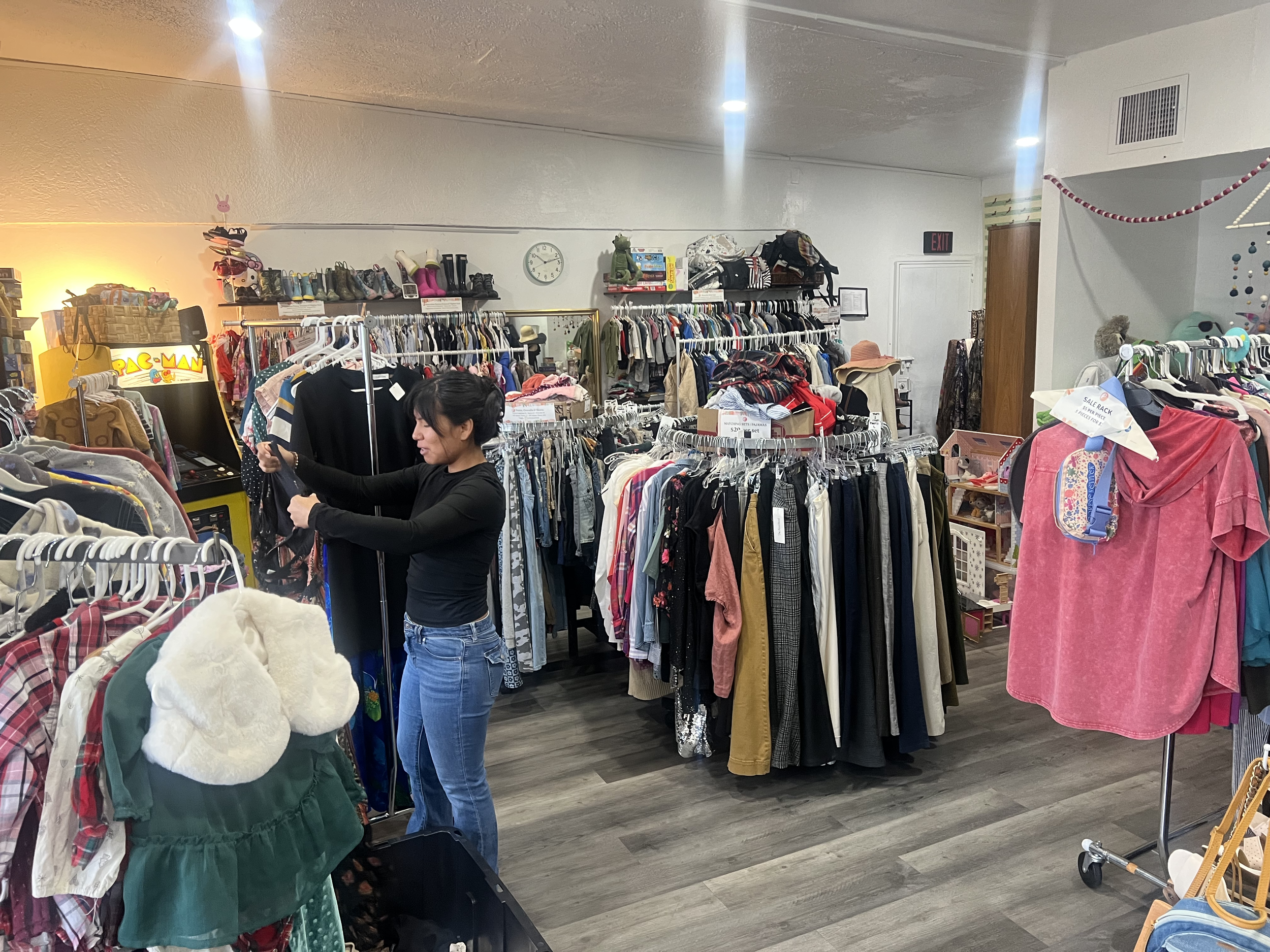 A customer shopping at Share Club, a thrift store and community space in West Adams / Jefferson Park