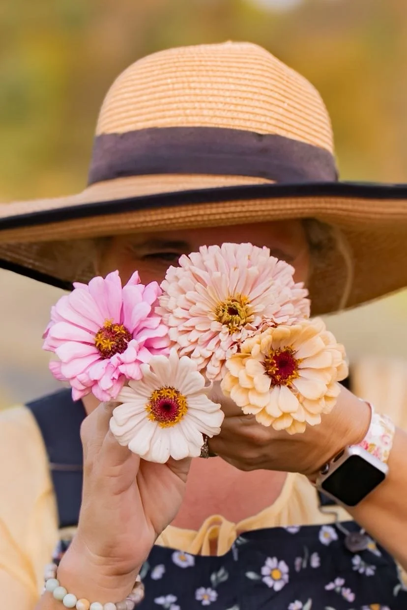 Girl holding zinnias