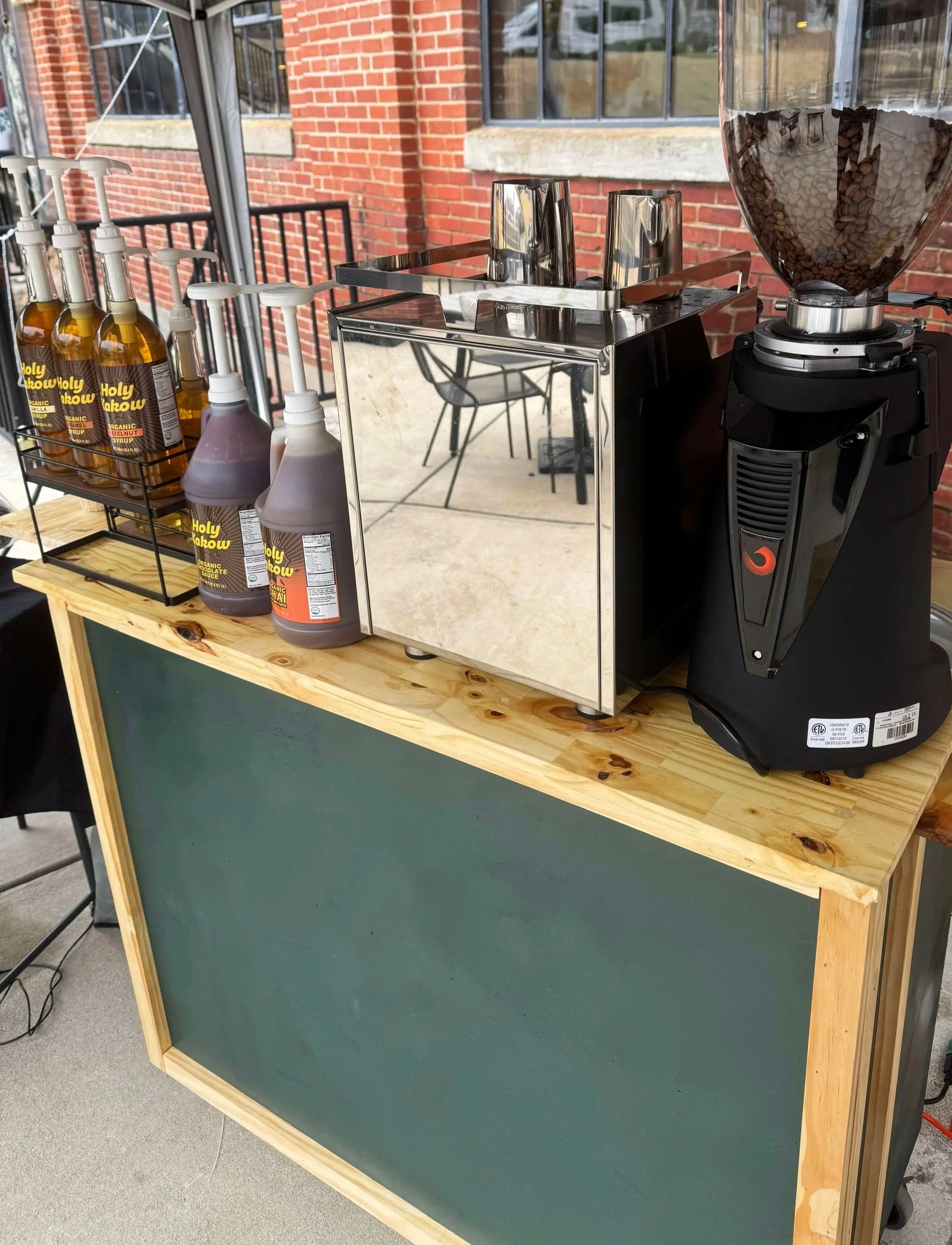 Our coffee cart featuring premium coffee, organic flavors, and delicious textured milk. We can bring this cart to your next Charlotte event or wedding