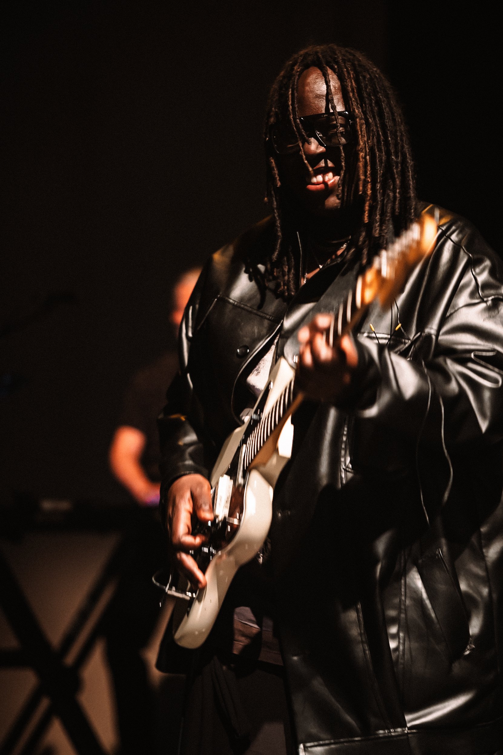 © 2026 LOWRI BURKINSHAW | Dave Okumu performing with Yannis & The Yaw at O2 Shepherd's Bush Empire