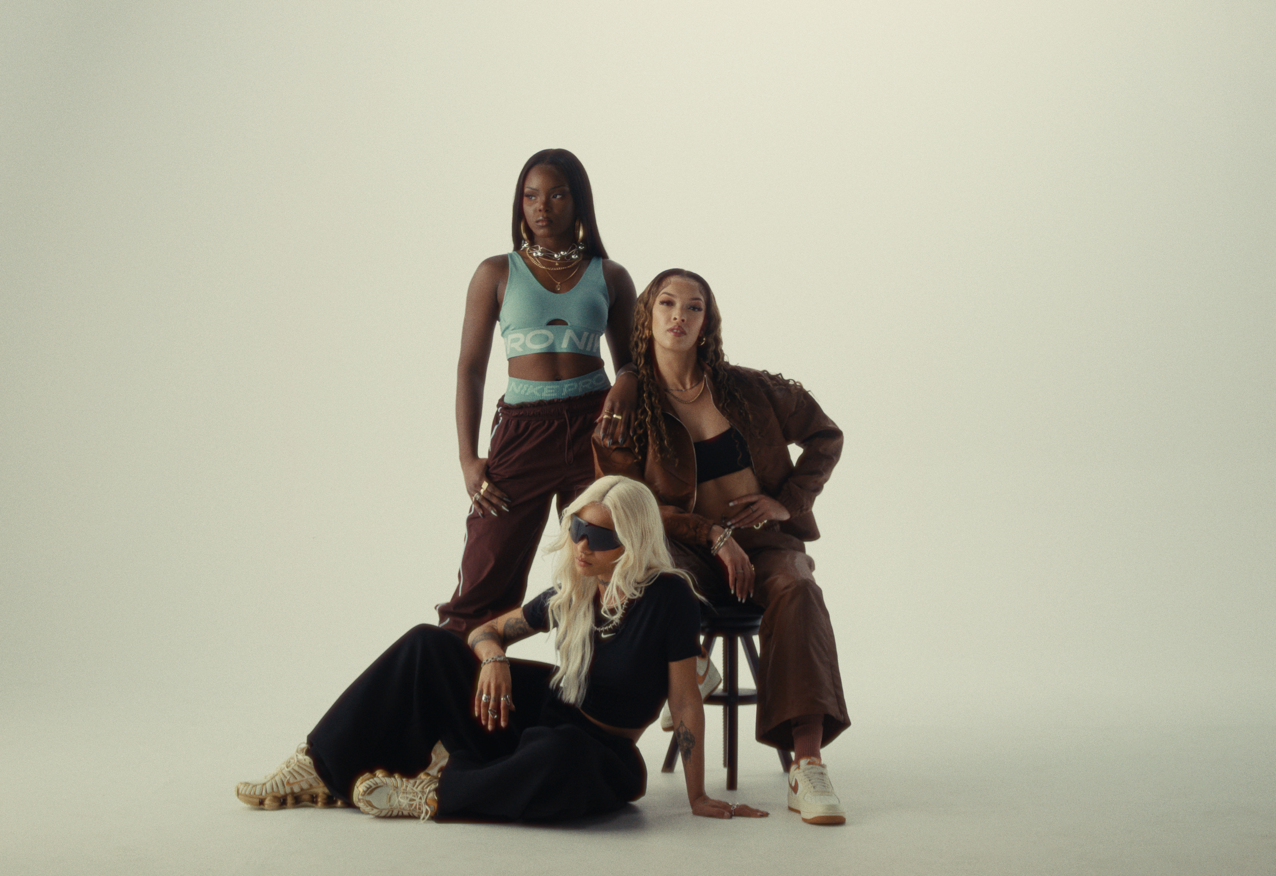 Three women wearing Nike shoes for JD Sports US Golden Hour Collection on a film shoot commercial