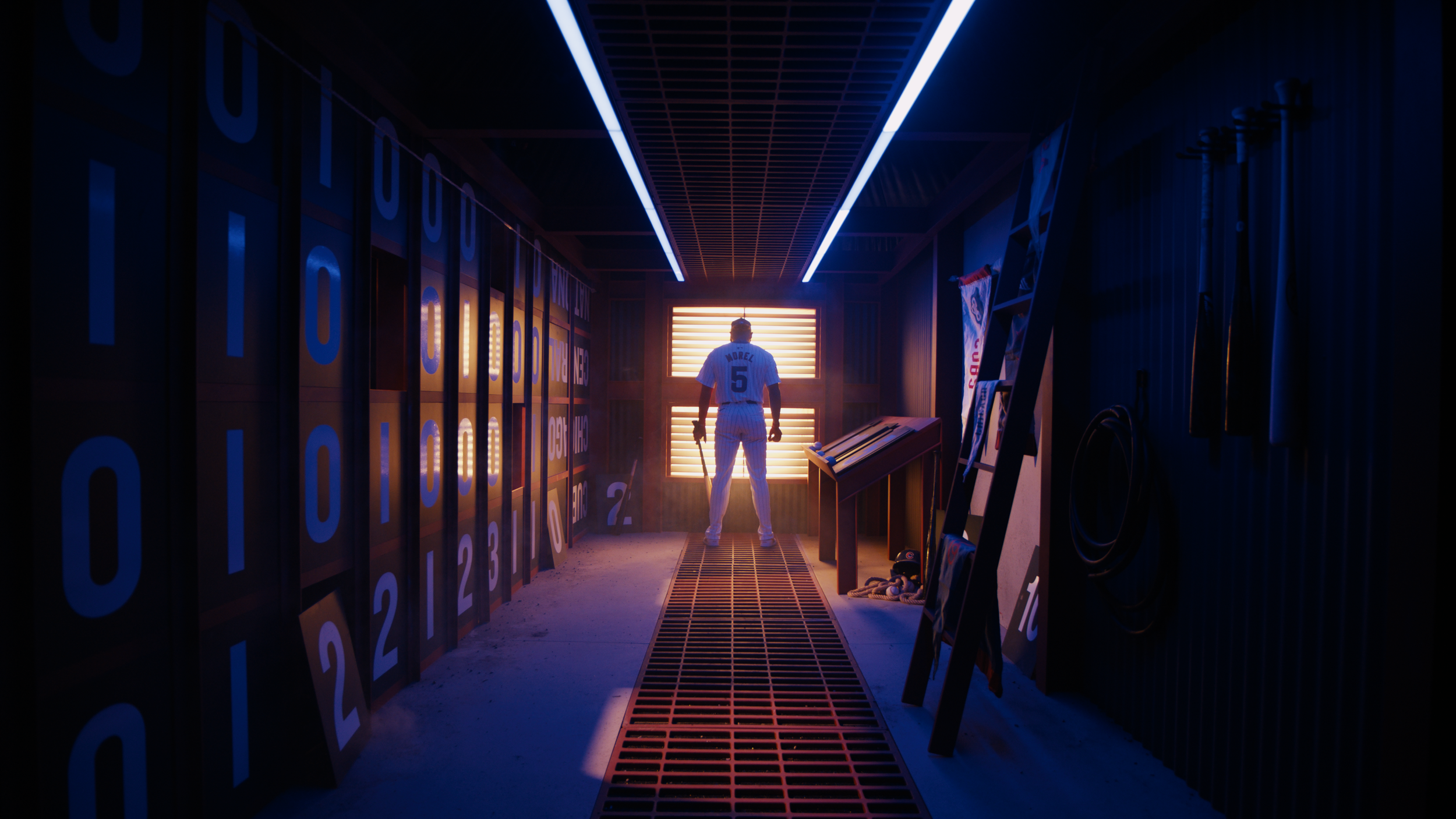 A baseball player in uniform stands facing a brightly lit door with blinds, inside a dark, tunnel-like room filled with sports memorabilia and lockers.