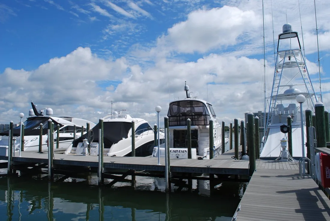 Boats Parked in Slips on Dock