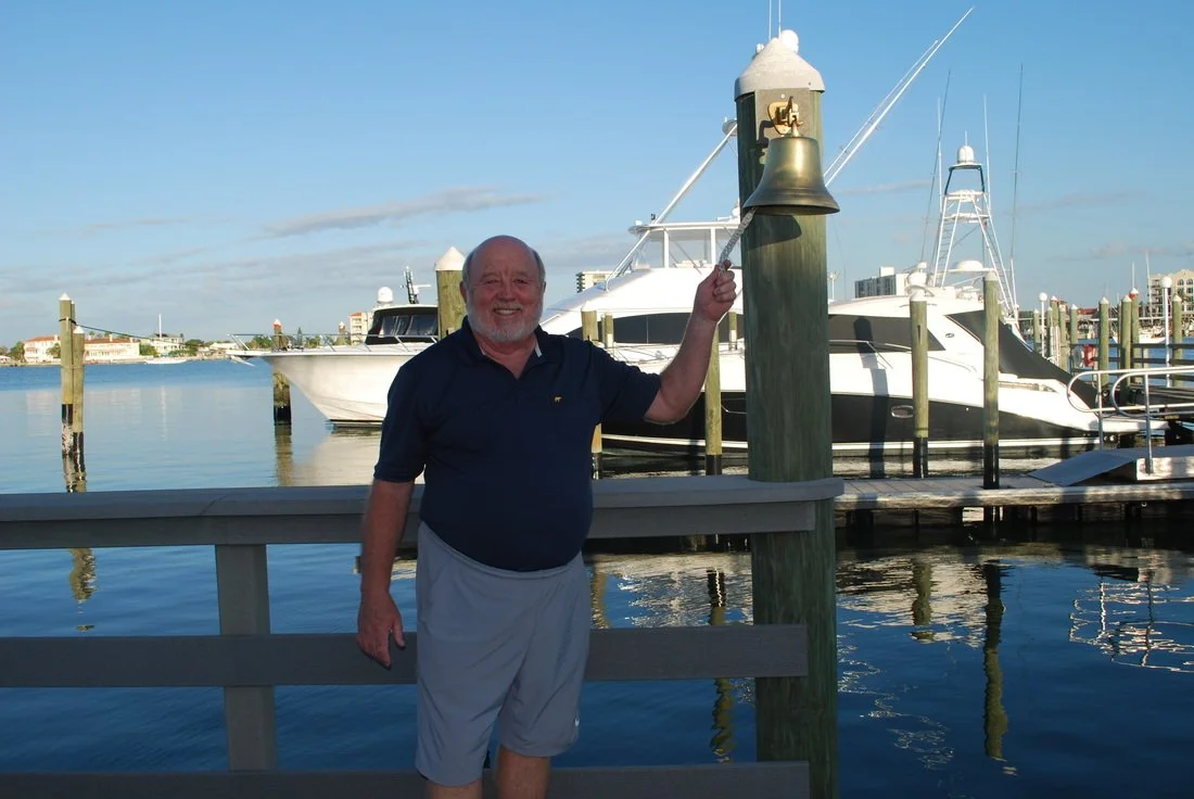 Guest Holding up Fish on Dock