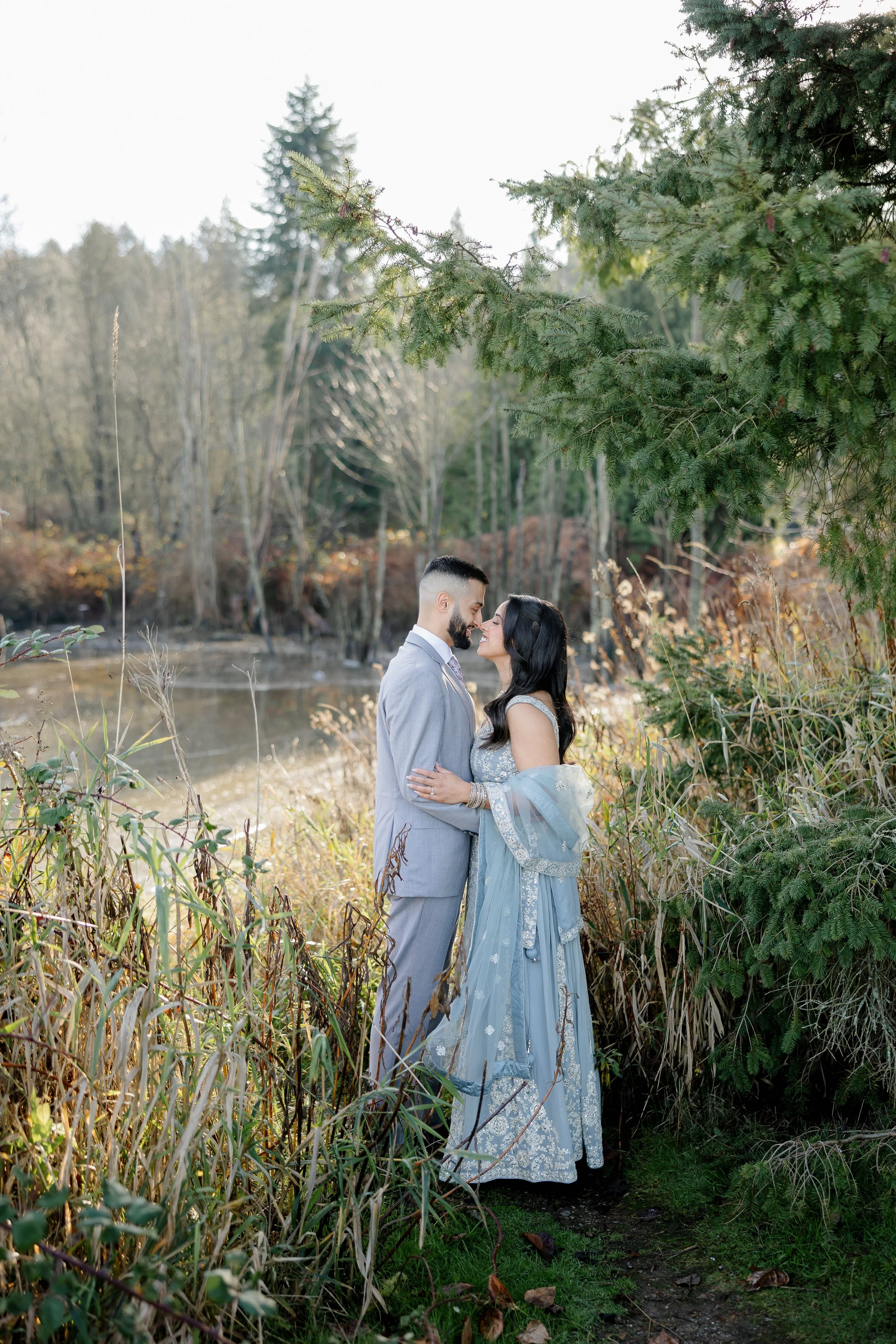 Engagement couple standing together in a forest