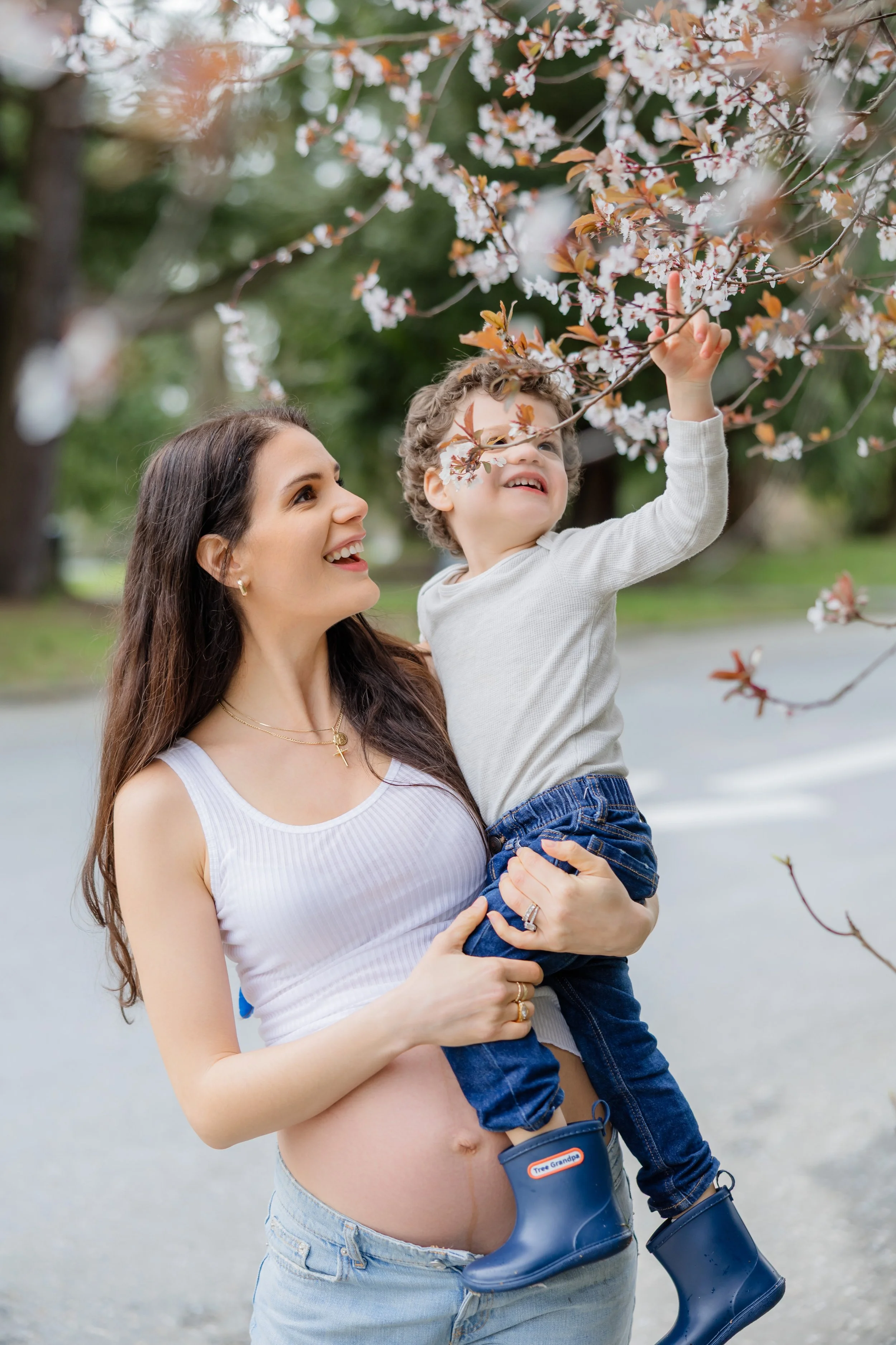 Mom and toddler under cherry blossoms