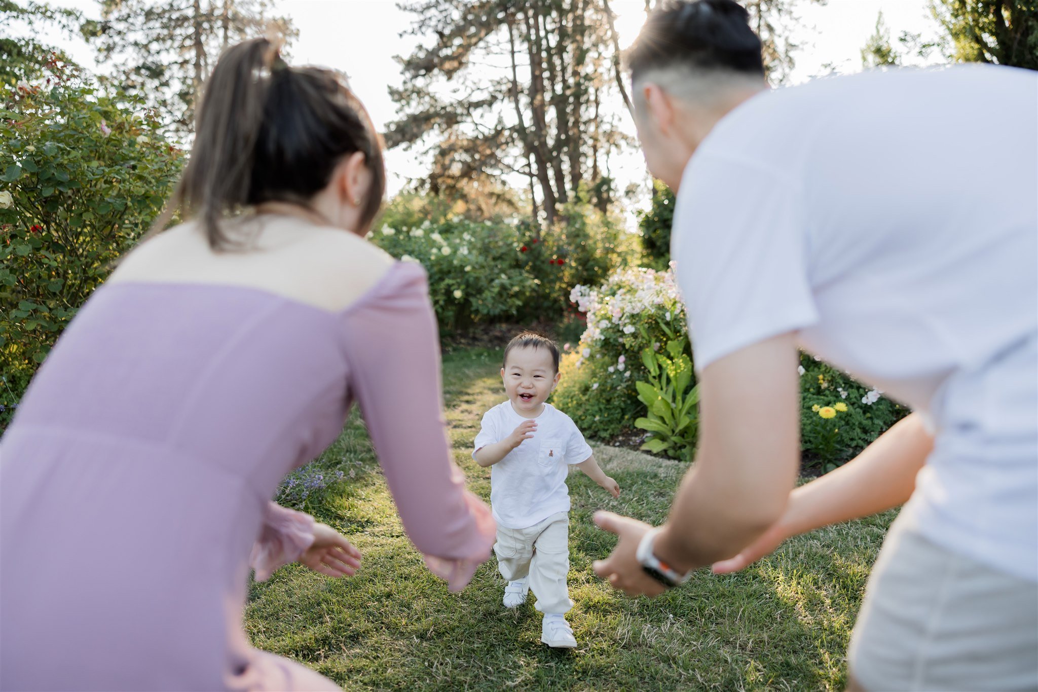 Parents playing with their toddler in the park