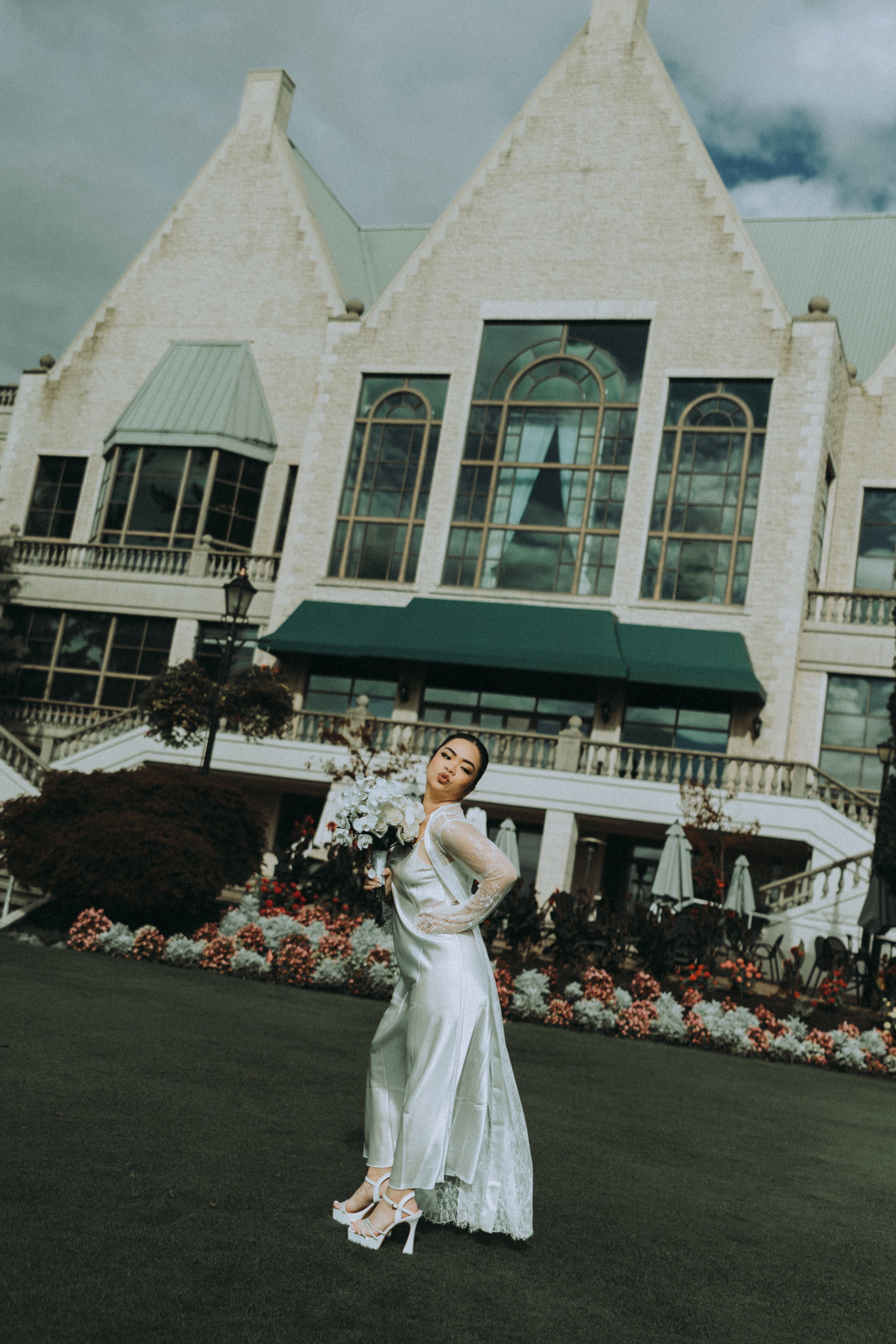 A woman in a white wedding dress holding a bouquet of white flowers at Swaneset Bay Resort & Country Club