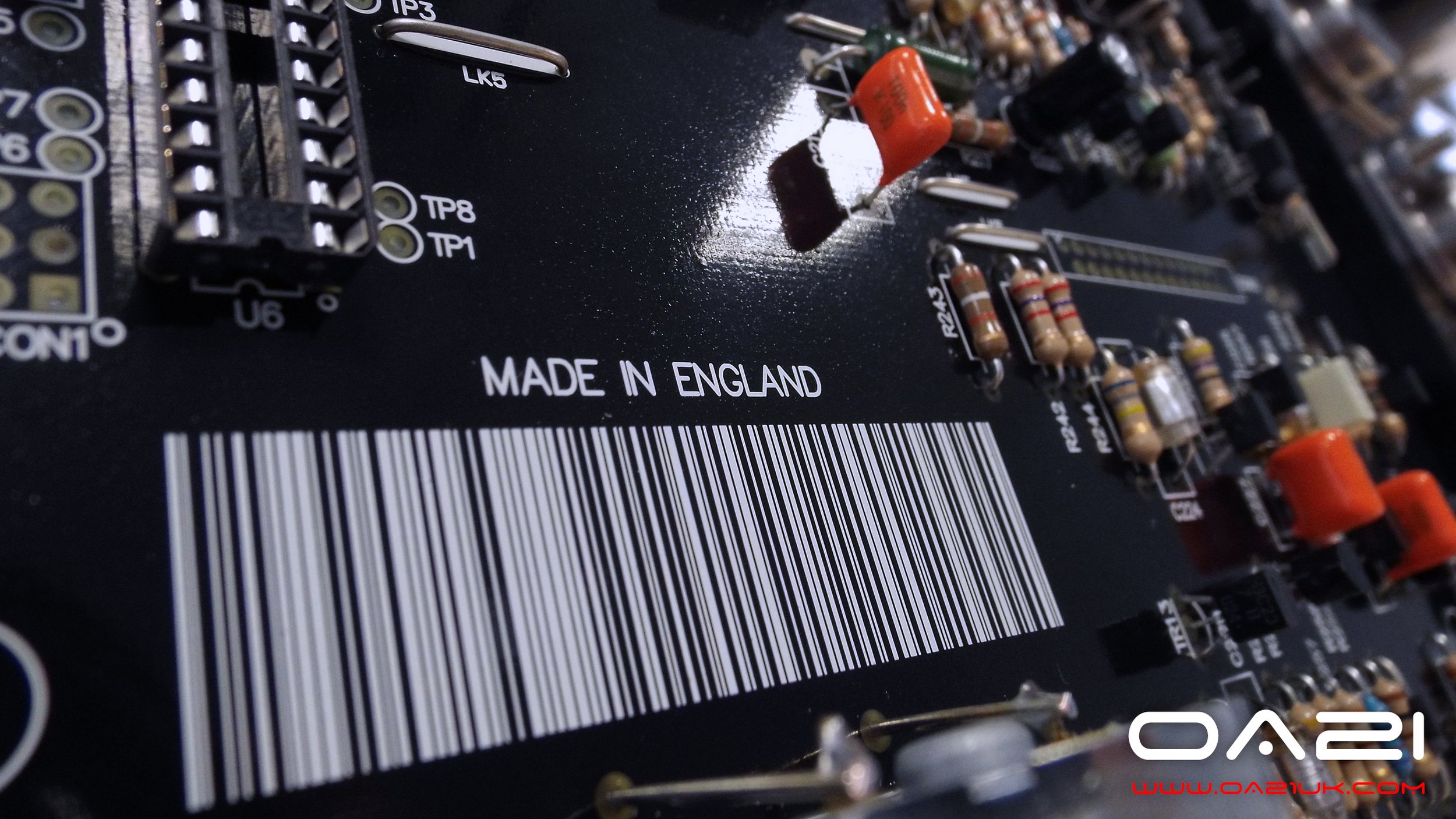 Close-up of a printed circuit board with electronic components, including resistors, capacitors, and connectors. ONIX AUDIO & OA21  'MADE IN ENGLAND  (C)  www.oa21.com