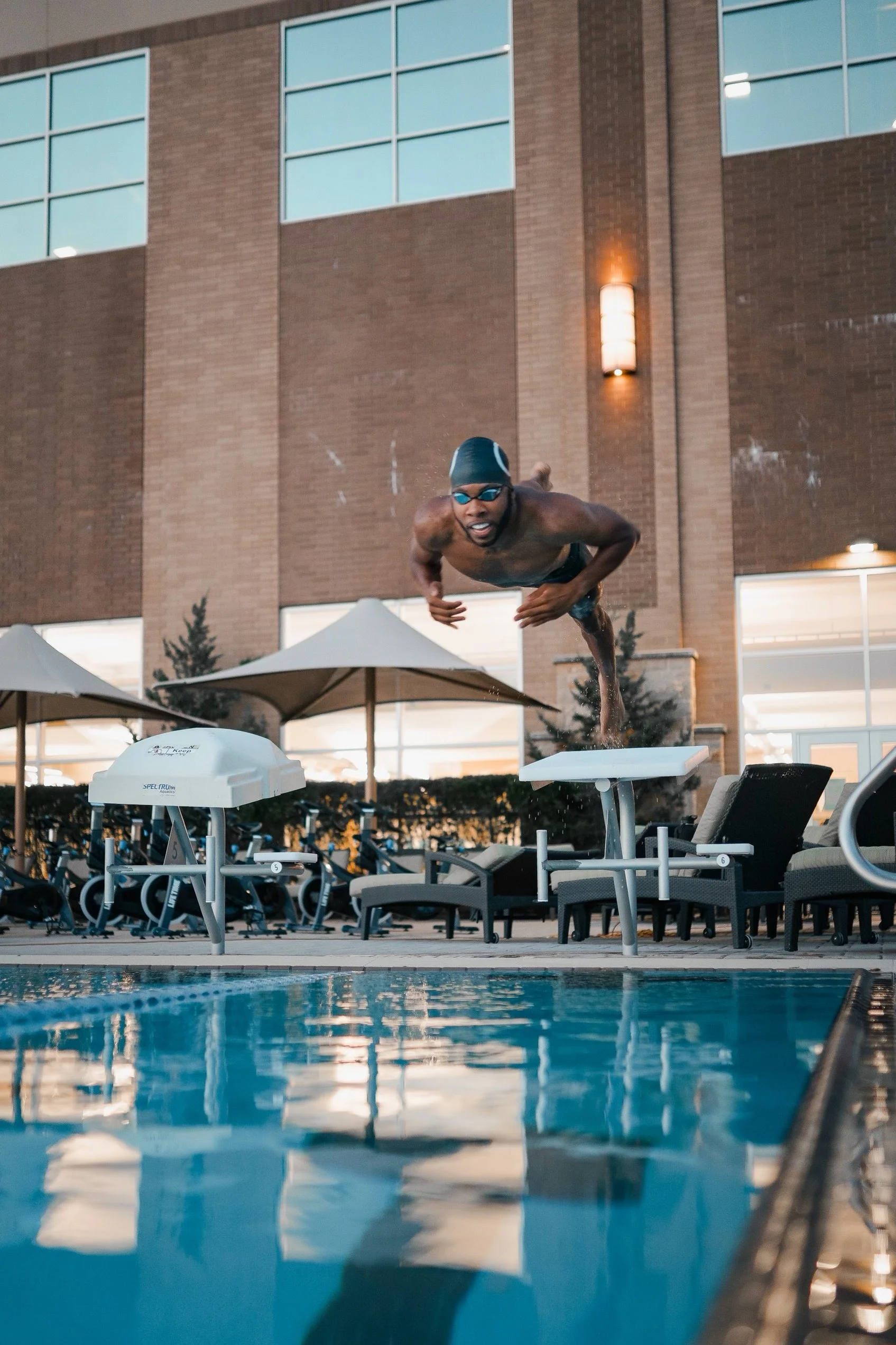 Coach DK diving in pool - competitive swim training