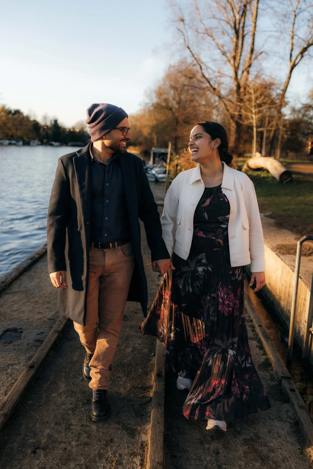 Couple walking hand in hand beside the water