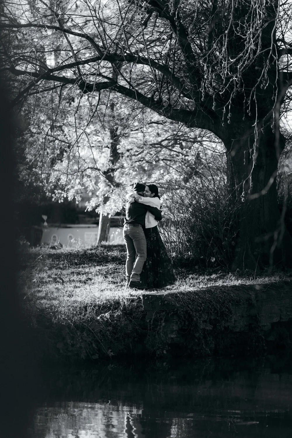 Black and white photograph of the couple embracing after their proposal