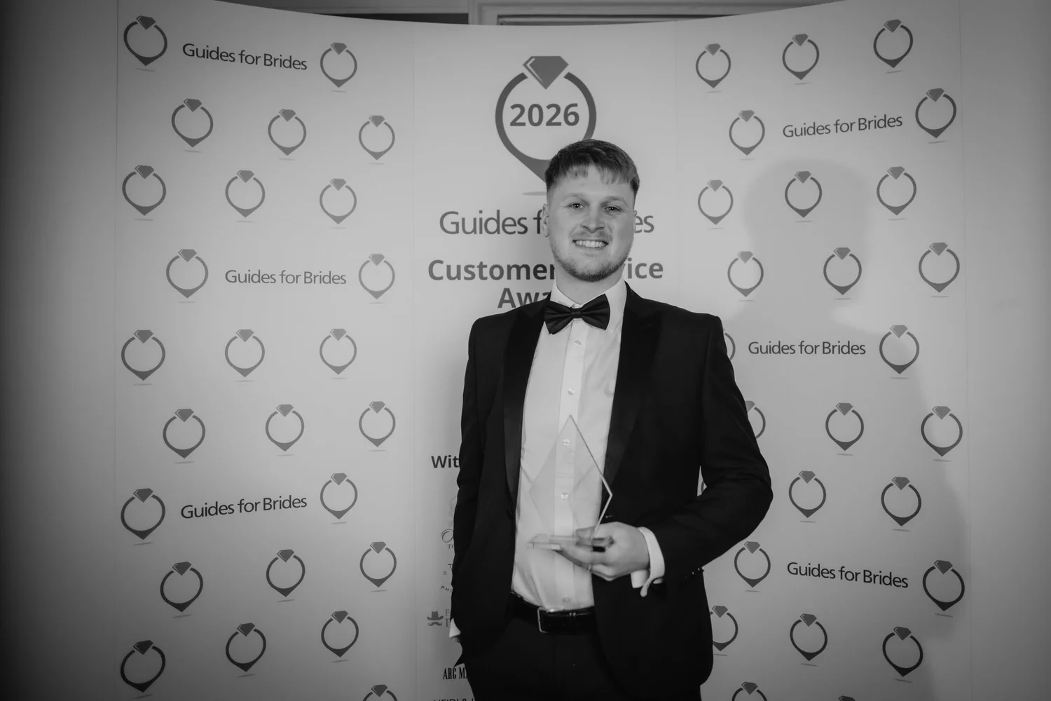 Alex Green holding his award at the Guides for Brides Customer Service Awards 2026