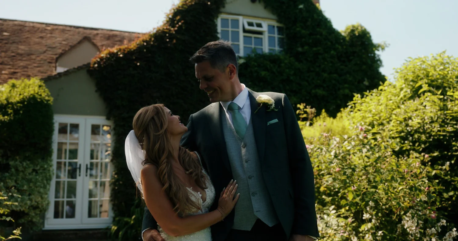 Carli and Neil photographed beside the farmhouse at Old Luxters Barn