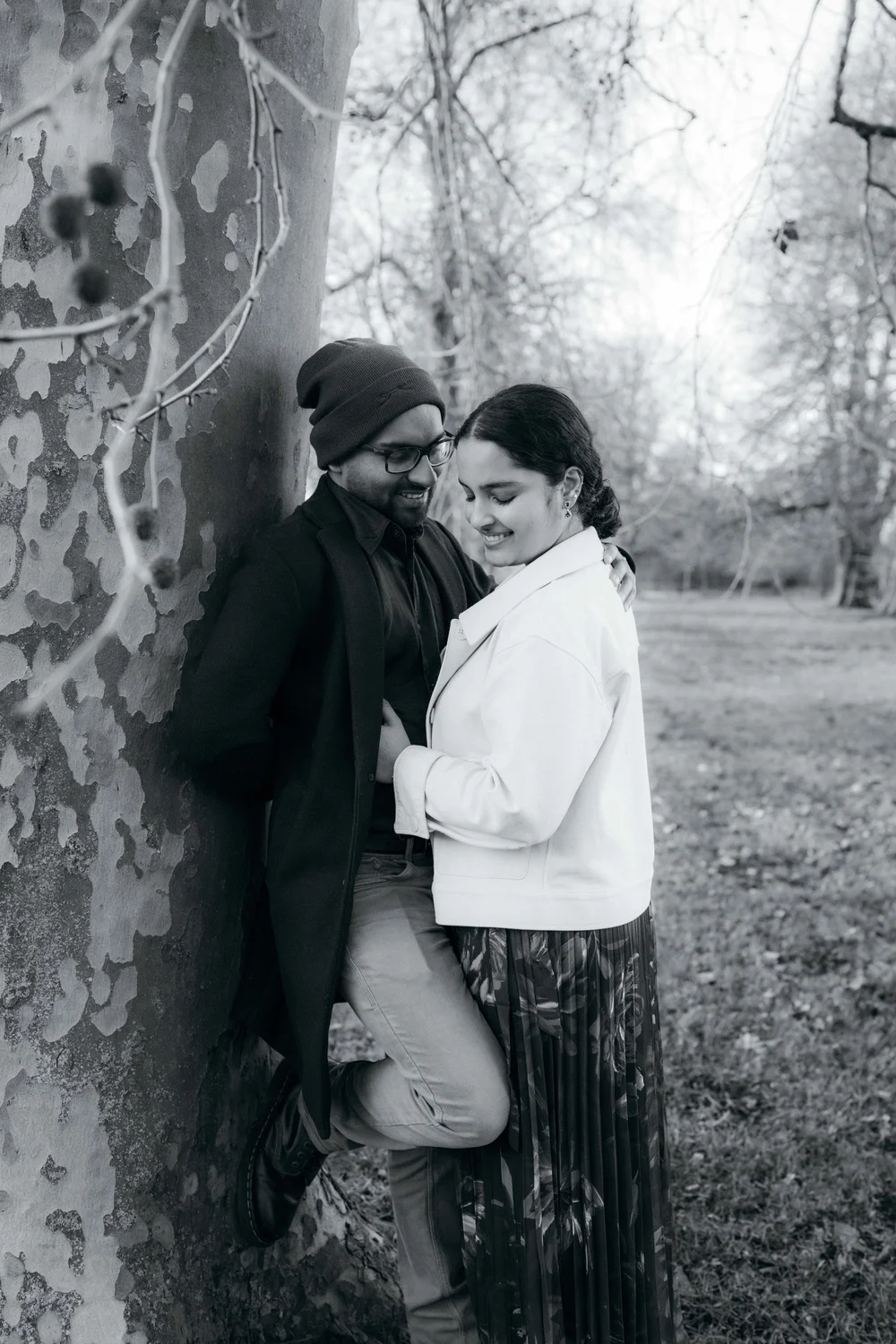 Relaxed engagement portrait beside an autumn tree