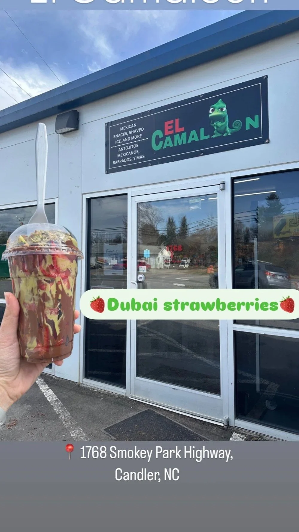 Hand holding a cup of chocolate and strawberry syrup mixed ice cream outside a restaurant named El Camaleon with a sign mentioning Mexican snacks, shaved ice, and more, located at 1768 Smokey Park Highway, Candler, NC.
