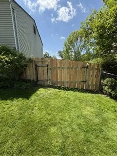 Custom backyard fence featuring a walk-through gate for easy access and a larger equipment gate (back)