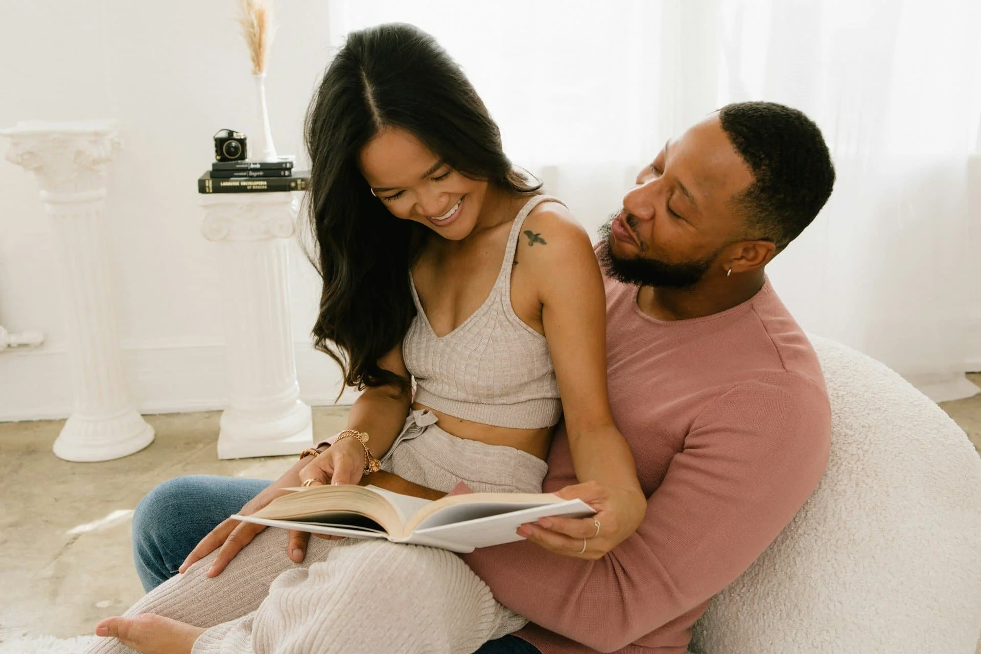 Mixed race couple laughing together during the morning hours.