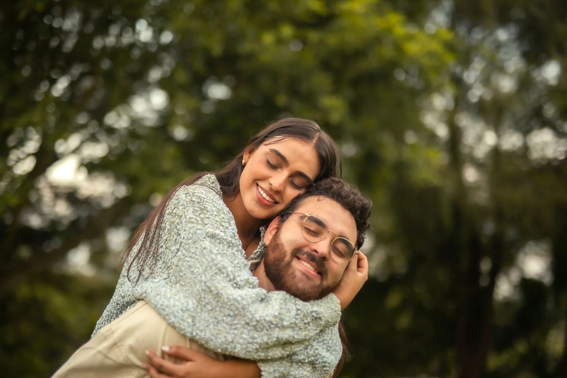 Young Latin couple embracing and sharing a happy moment together.