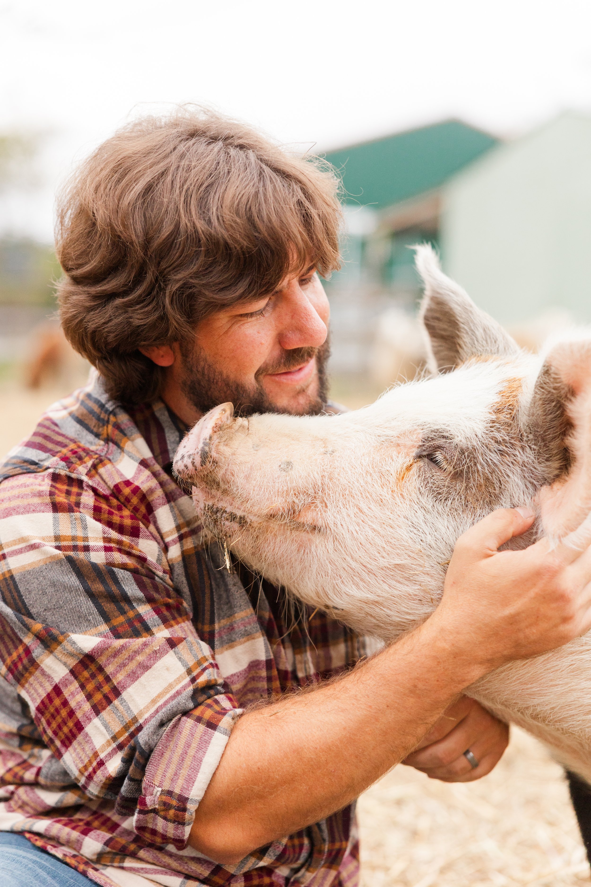 Bryan with rescued pig, Peebles, at Fabled Farm Rescue