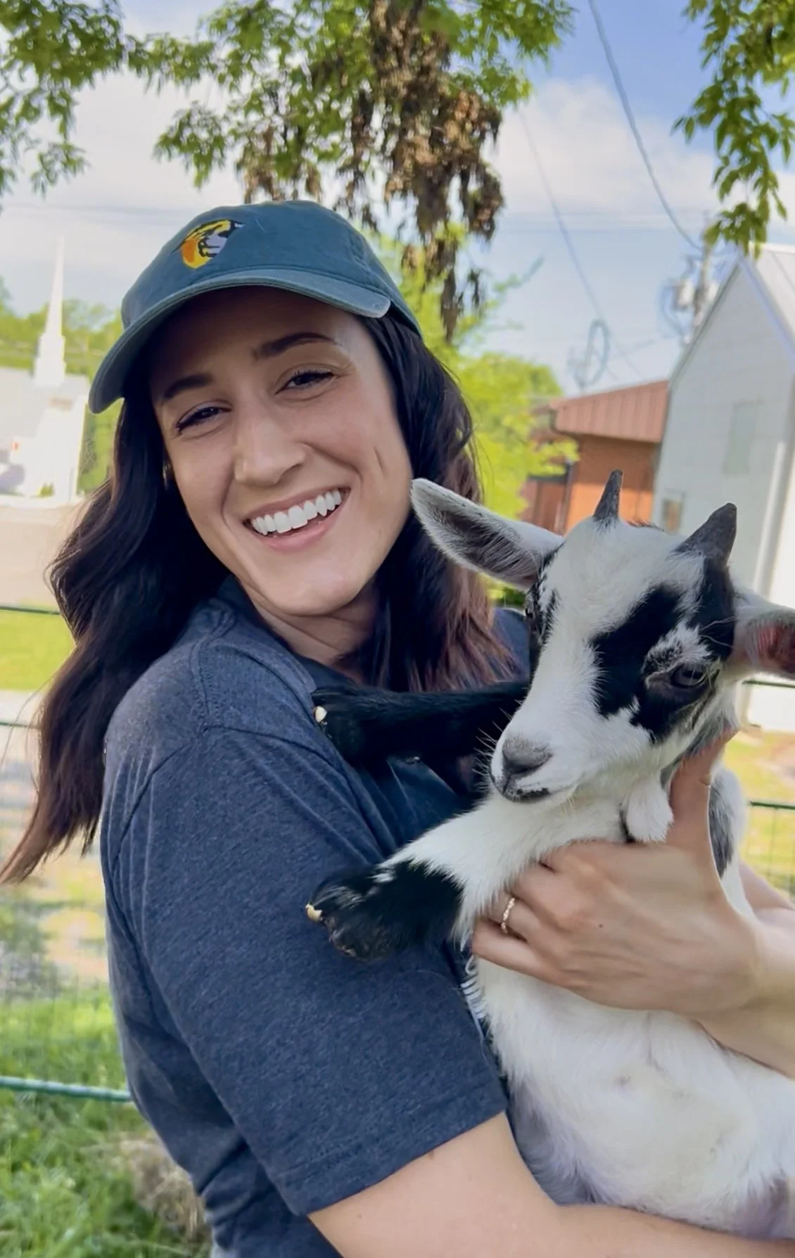 Volunteer at event with baby goat