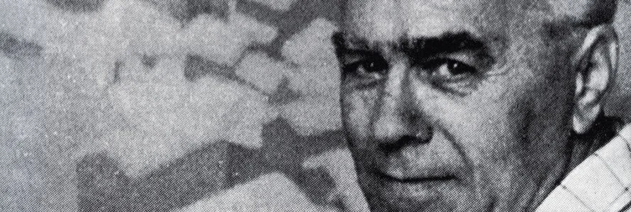 Black and white photograph of a man with short hair looking at the camera