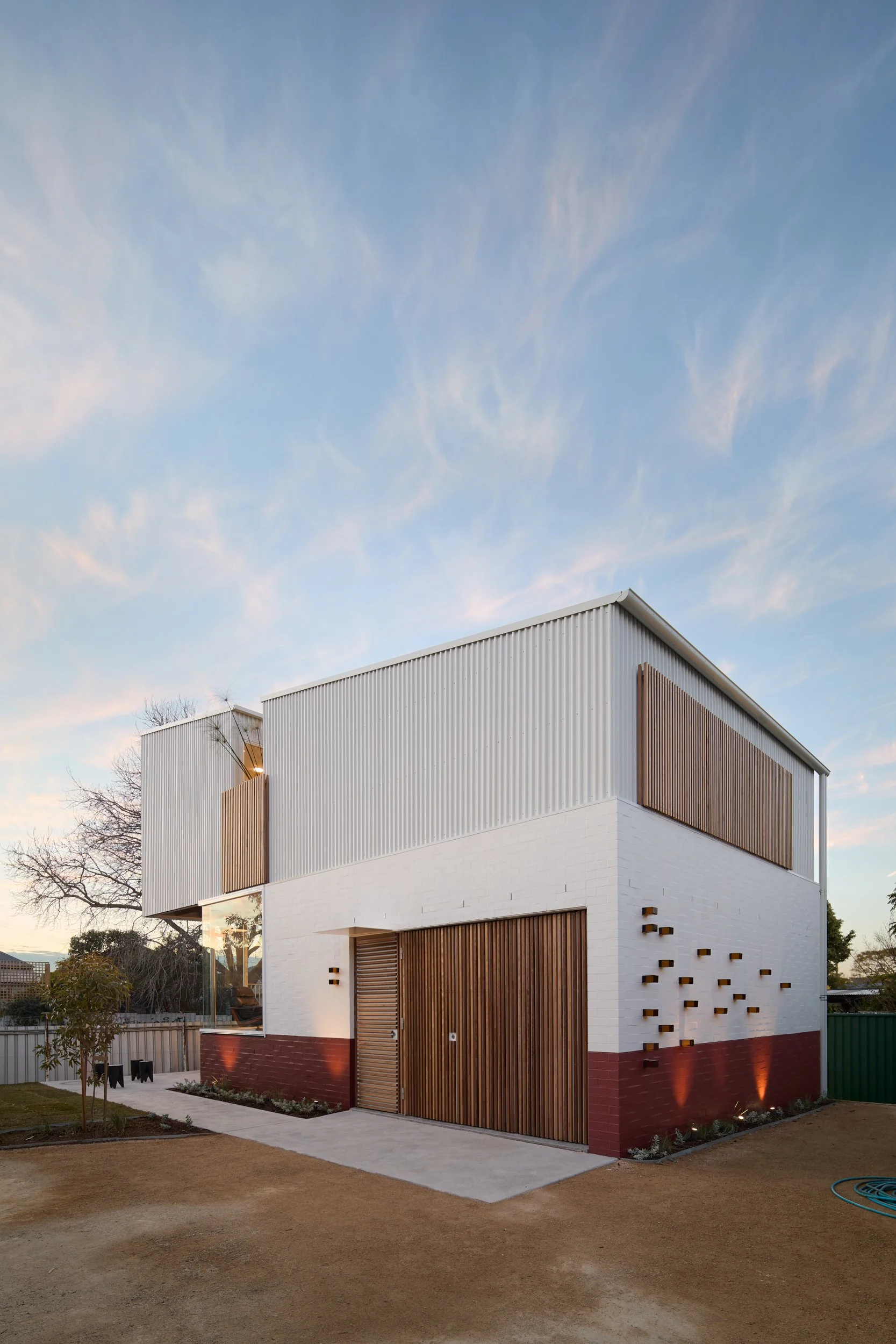 Custom New Build in Newcastle with Colorbond cladding, Hemlock battens, custom garage door