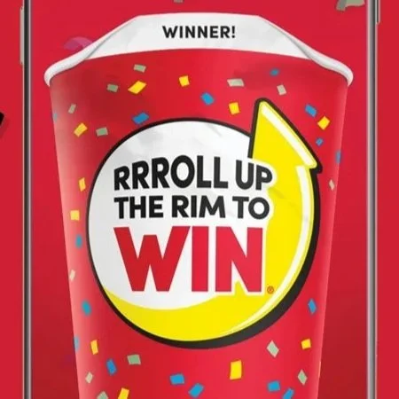 A Tim Horton's coffee cup with Roll up the Rim to Win printed on it