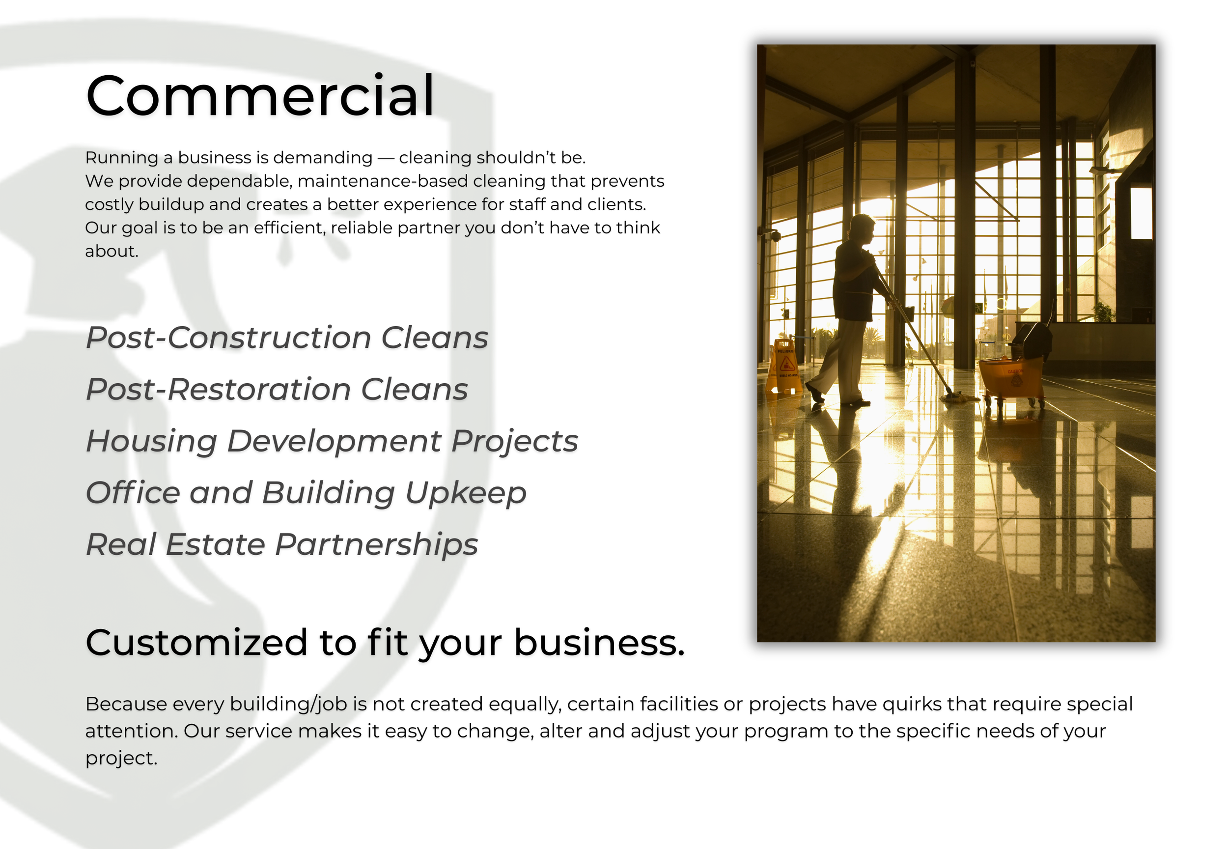 Silhouette of a janitor cleaning the floor inside a modern building with large glass windows, during sunset.