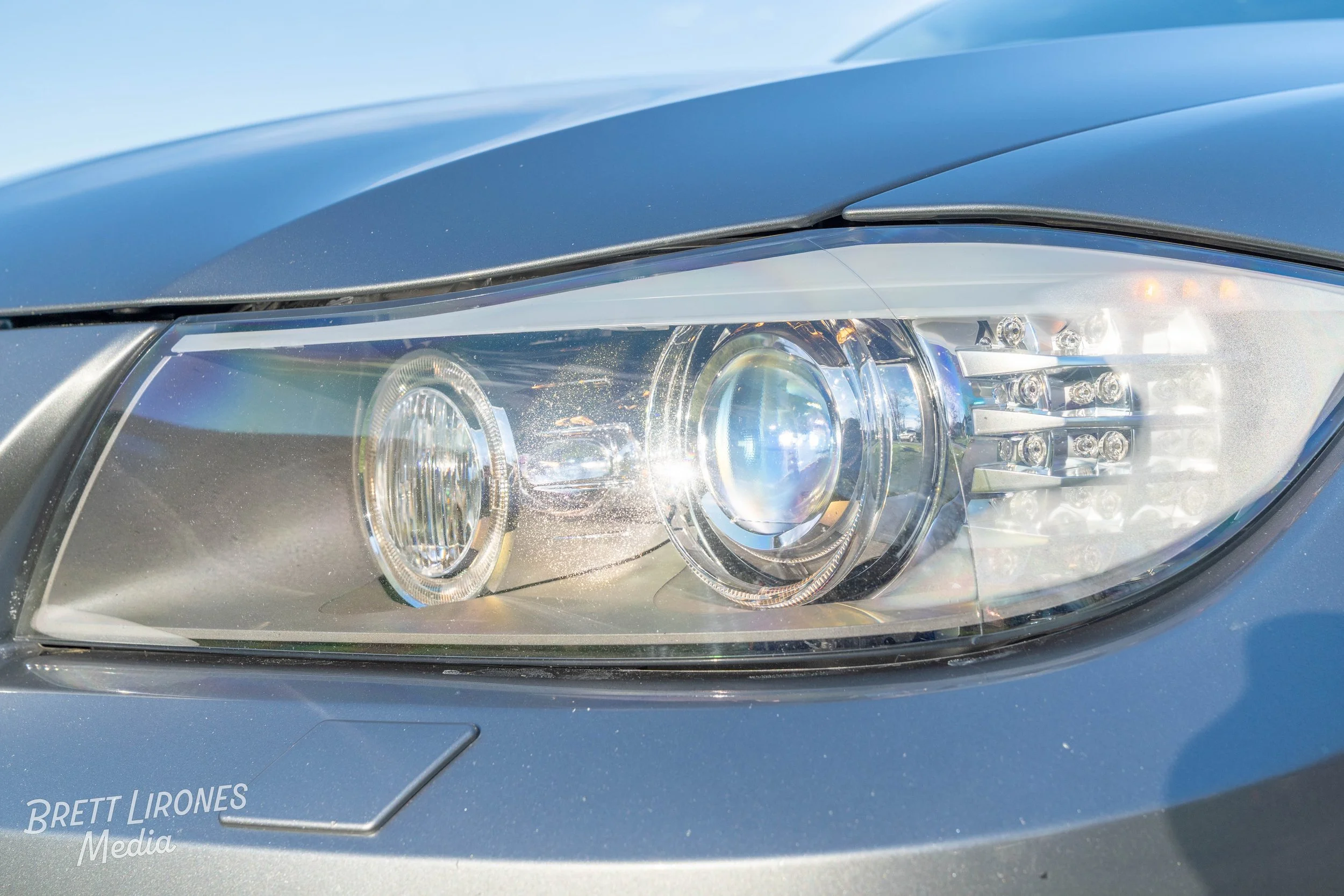 Close-up of a modern car headlight with a sleek design and multiple LED lights inside.