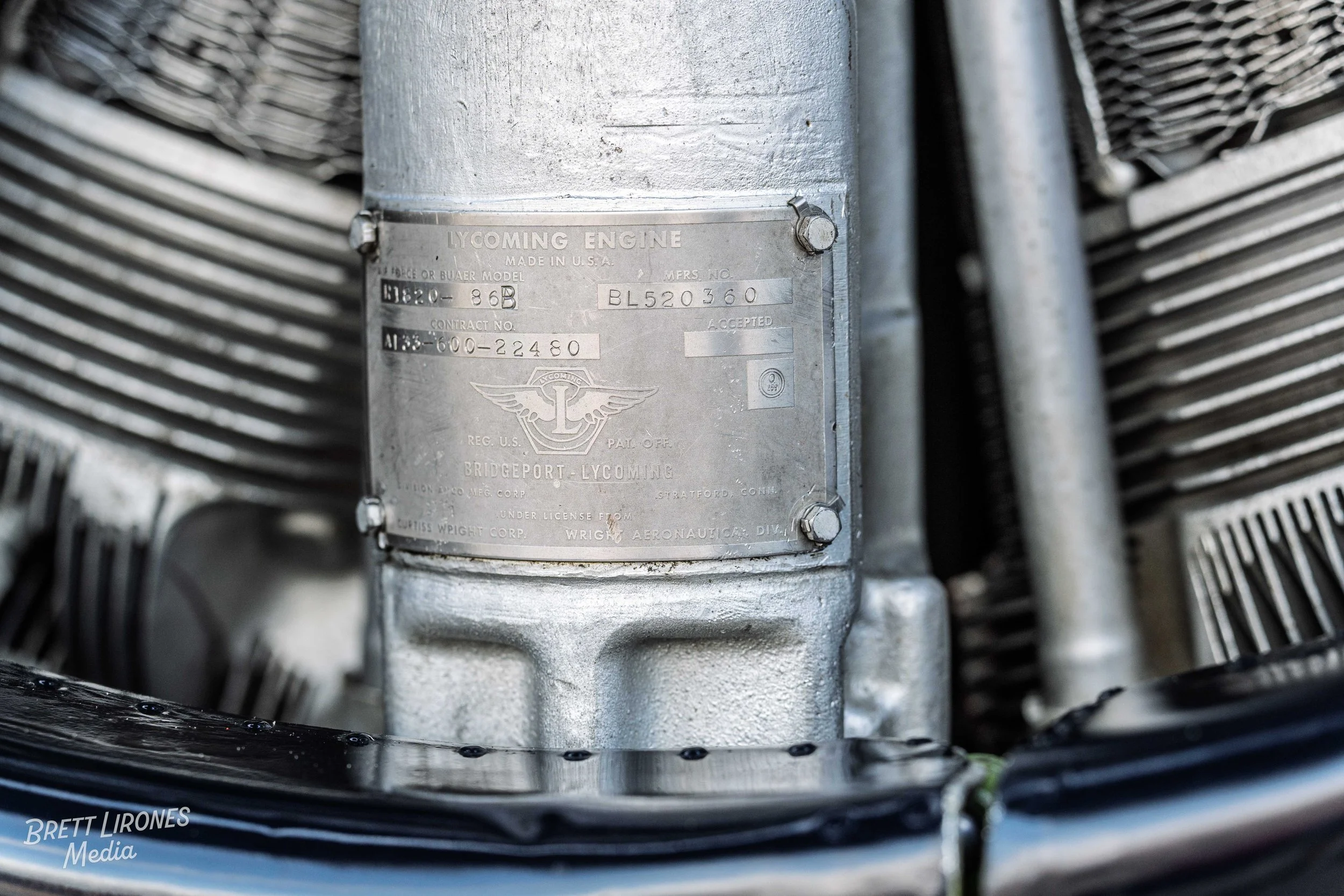 Close-up of a metal identification plate on a Lycoming aircraft engine, showing model, serial number, and manufacturing details.