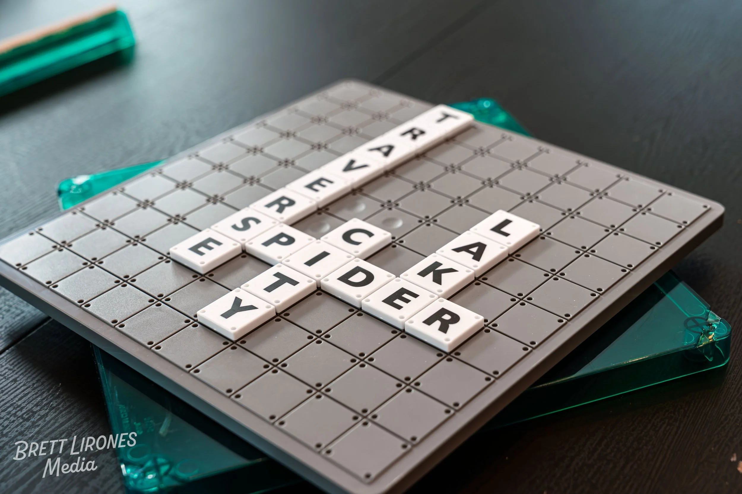 Scrabble game board with the words 'FRIEND' and 'PEACE' arranged on the board, and letter tiles on the rack.