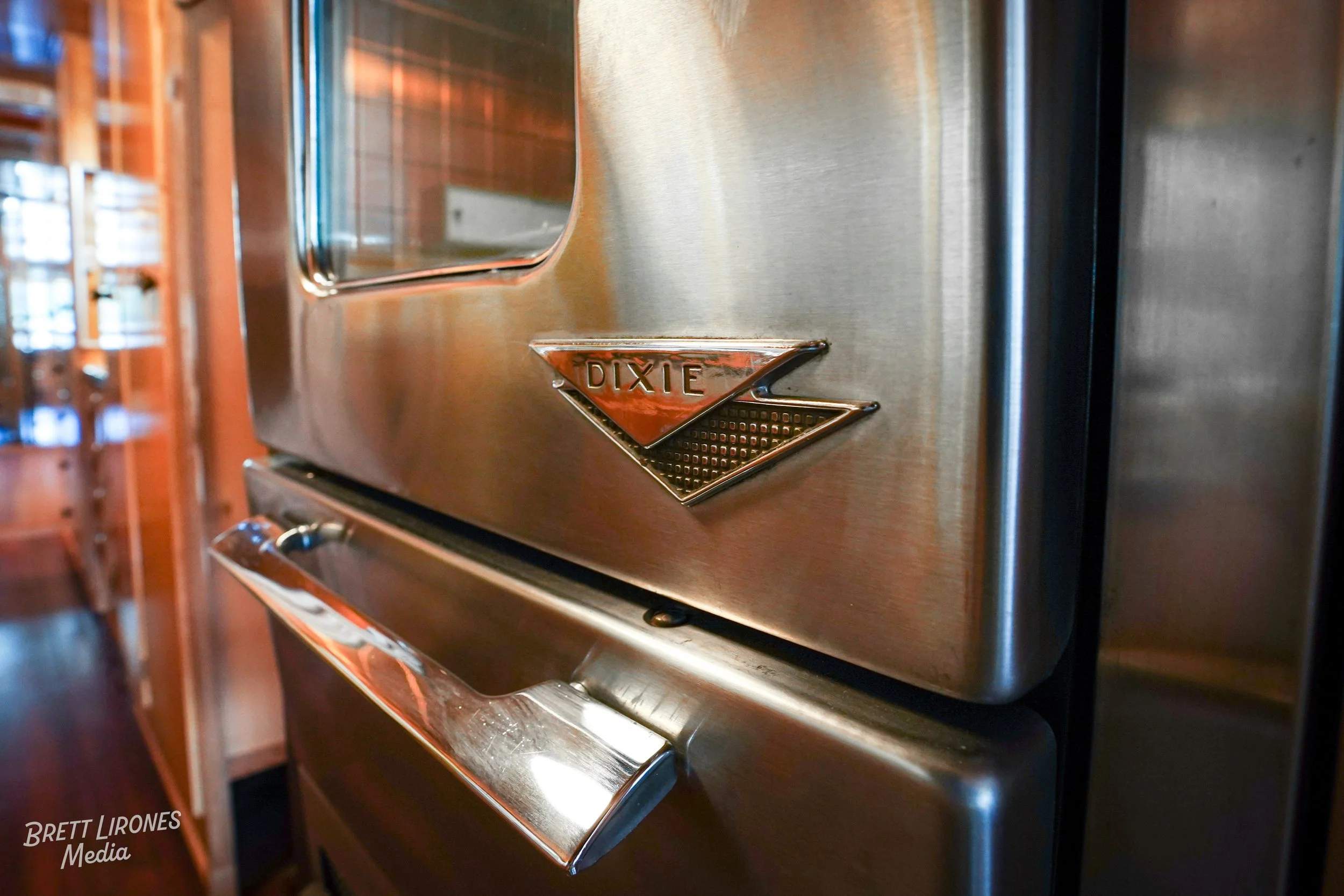 Close-up of a vintage stainless steel oven with a DIXIE emblem.