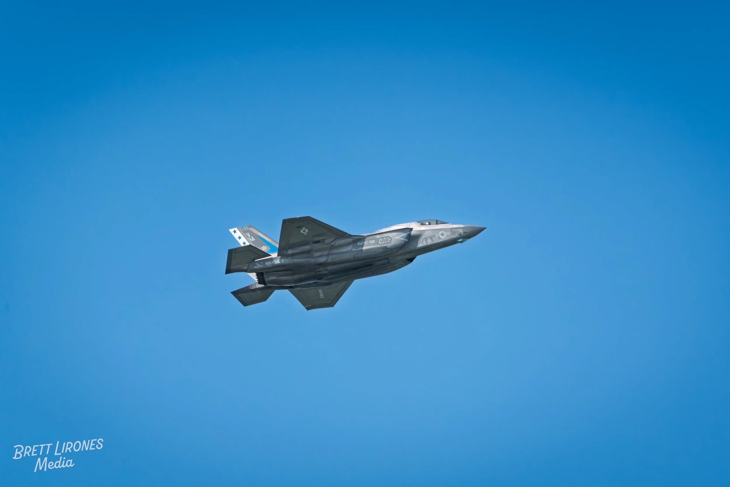 A fighter jet flying in a clear blue sky.