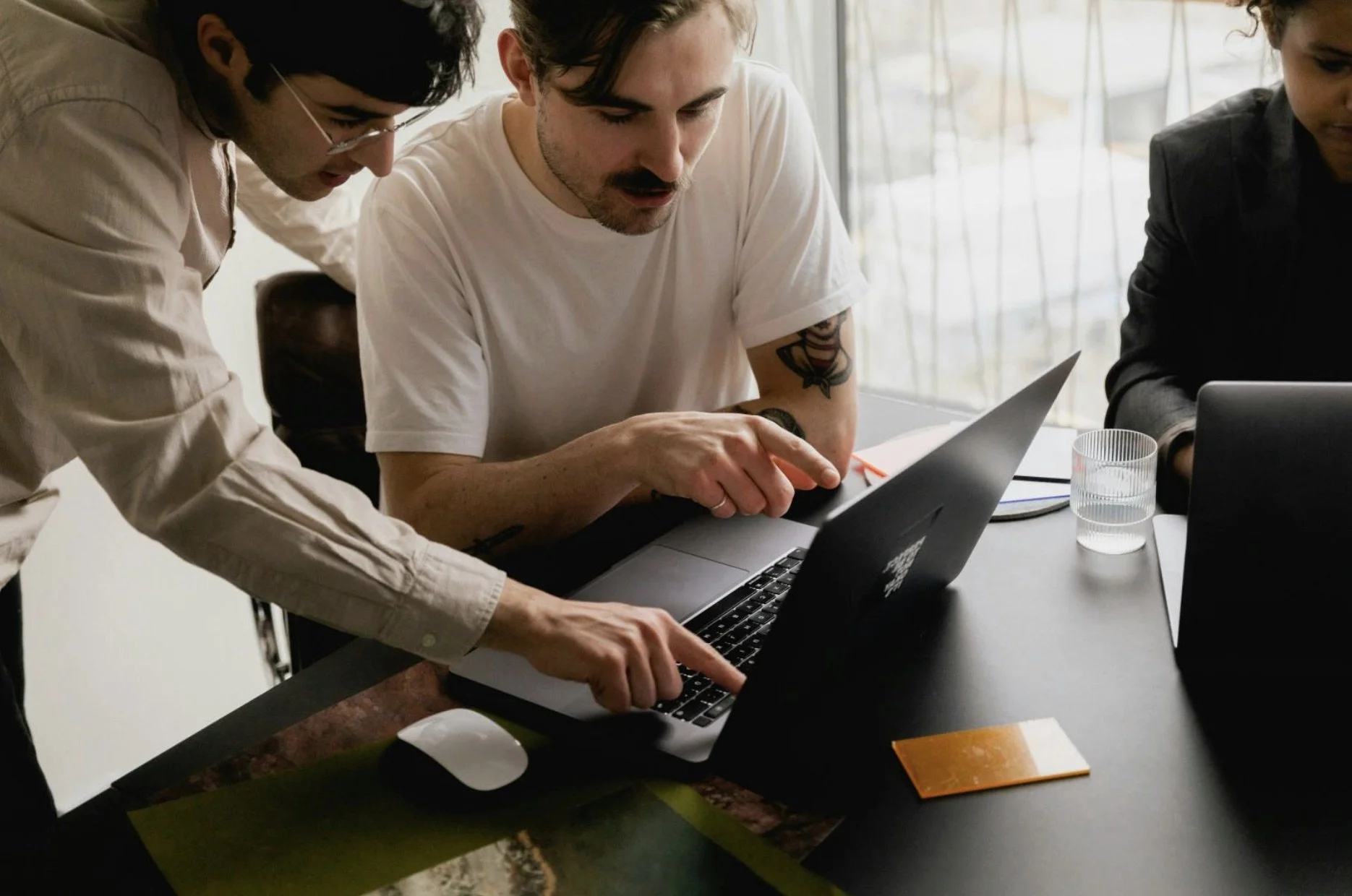 Two people reviewing a website together on a laptop.