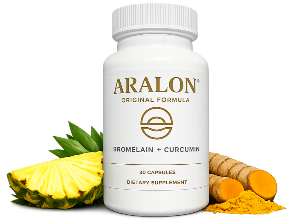 A supplement bottle labeled ARALON with bromelain and curcumin, surrounded by pineapple, turmeric roots, and turmeric powder.