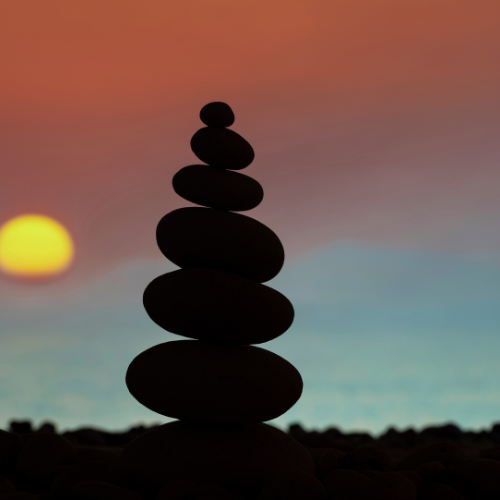 balanced stones at sunset symbolising calm and welcome counselling support