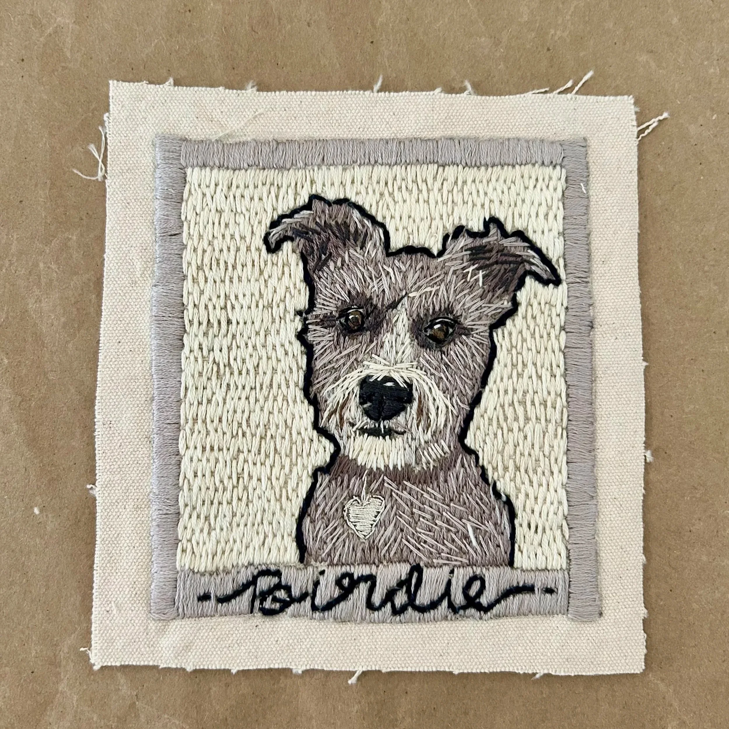 Birdie, the dog, hand-stitched in this custom pet portrait. Set against a creamy backdrop, this classic photo lets your pet be the central focus of these Warhol inspired custom pet portraits.