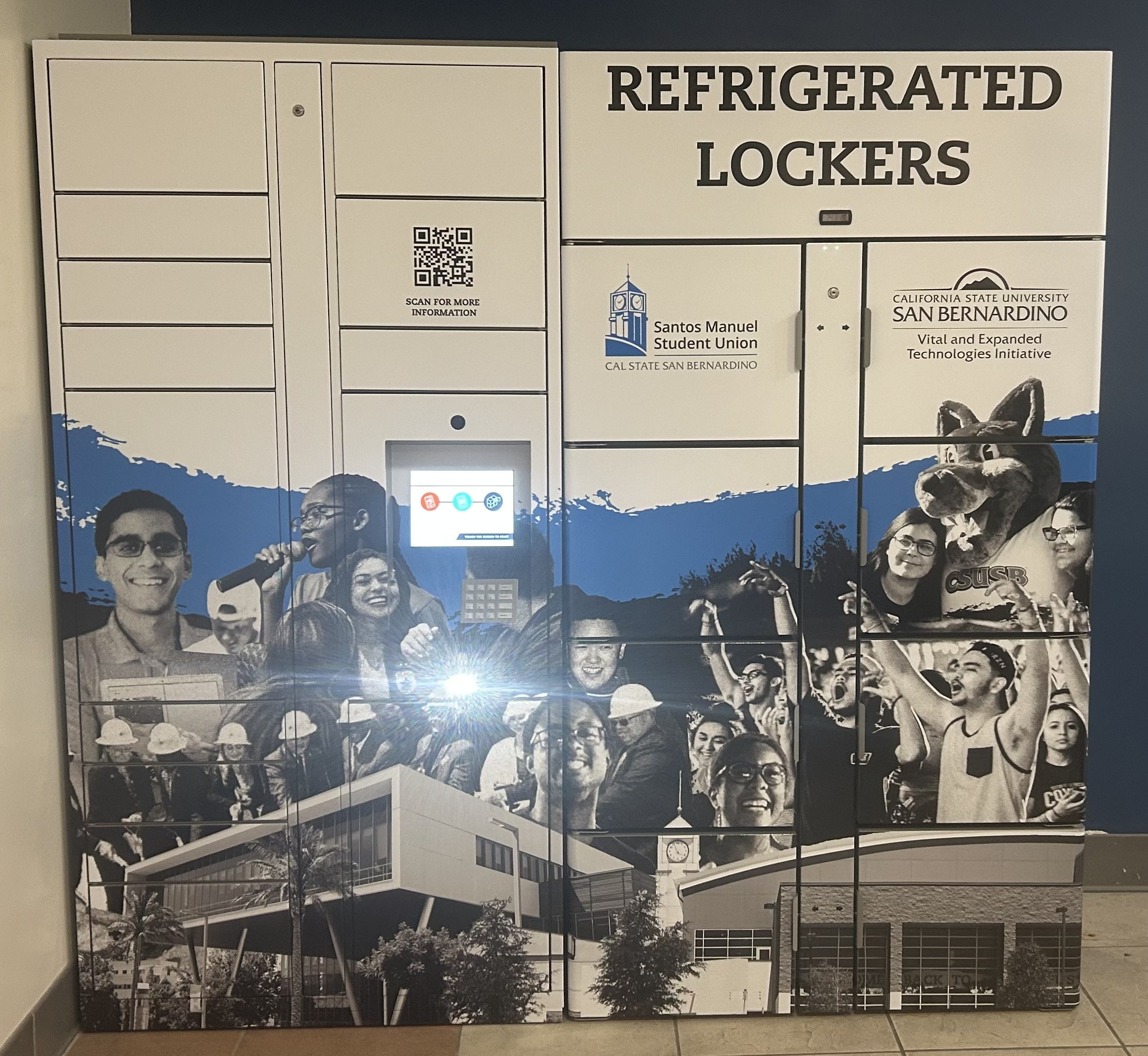Refrigerated lockers with black and white photos of students and campus buildings on the front, and logos for Santos Manuel Student Union and California State University San Bernardino.